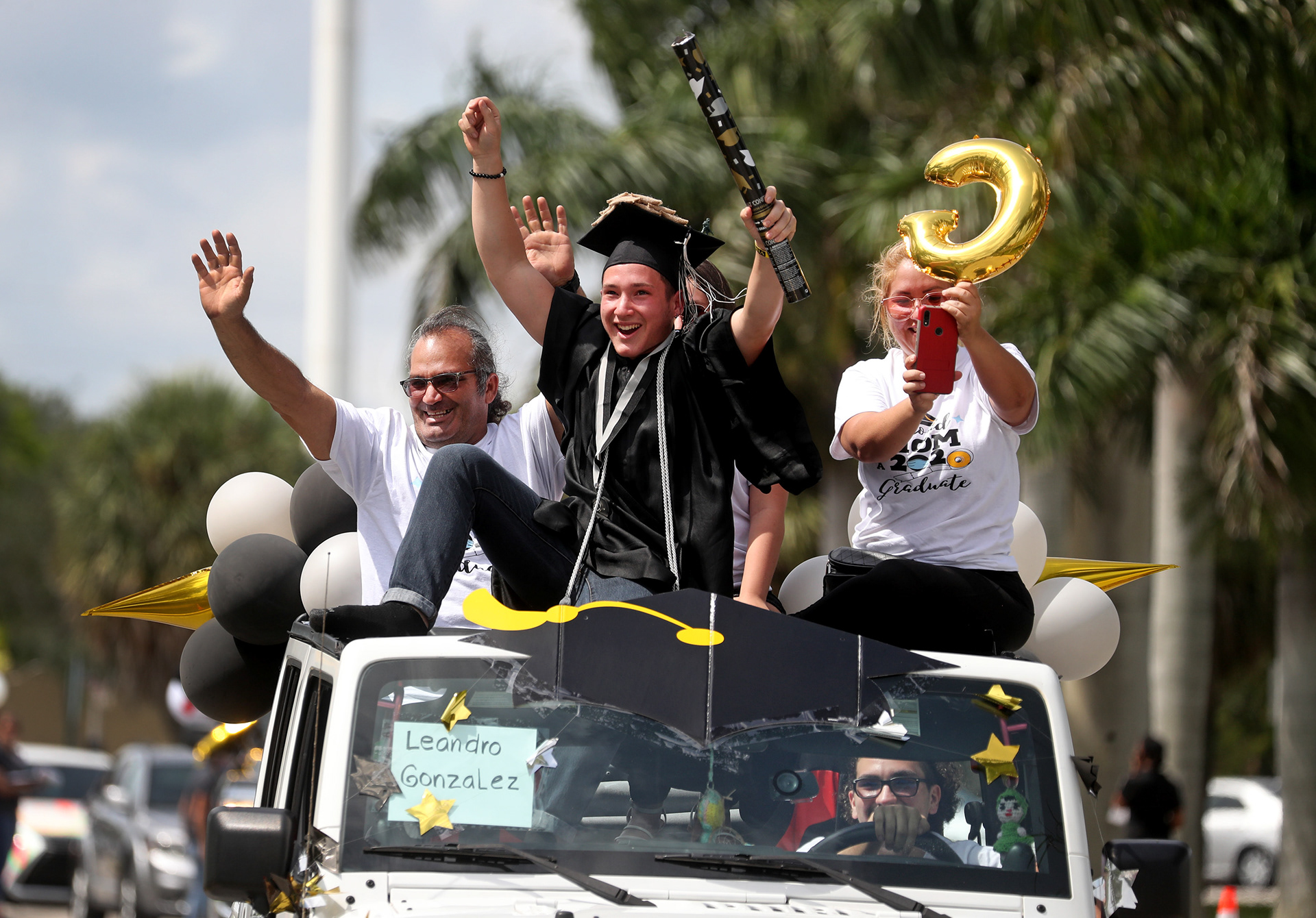 Leandro Gonzalez, an Everglades High School senior, celebrates with his family during a drive-through graduation ceremony in Miramar, Fl. during the COVID-19 pandemic in 2020.