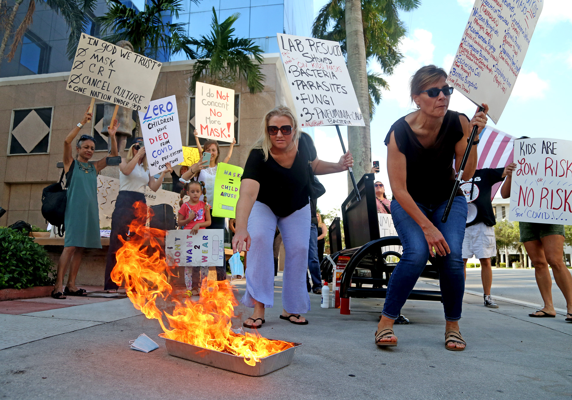 Anti-maskers burn masks outside the Broward Schools building in Fort Lauderdale, Fl. in 2021 to protest mask wearing in schools.