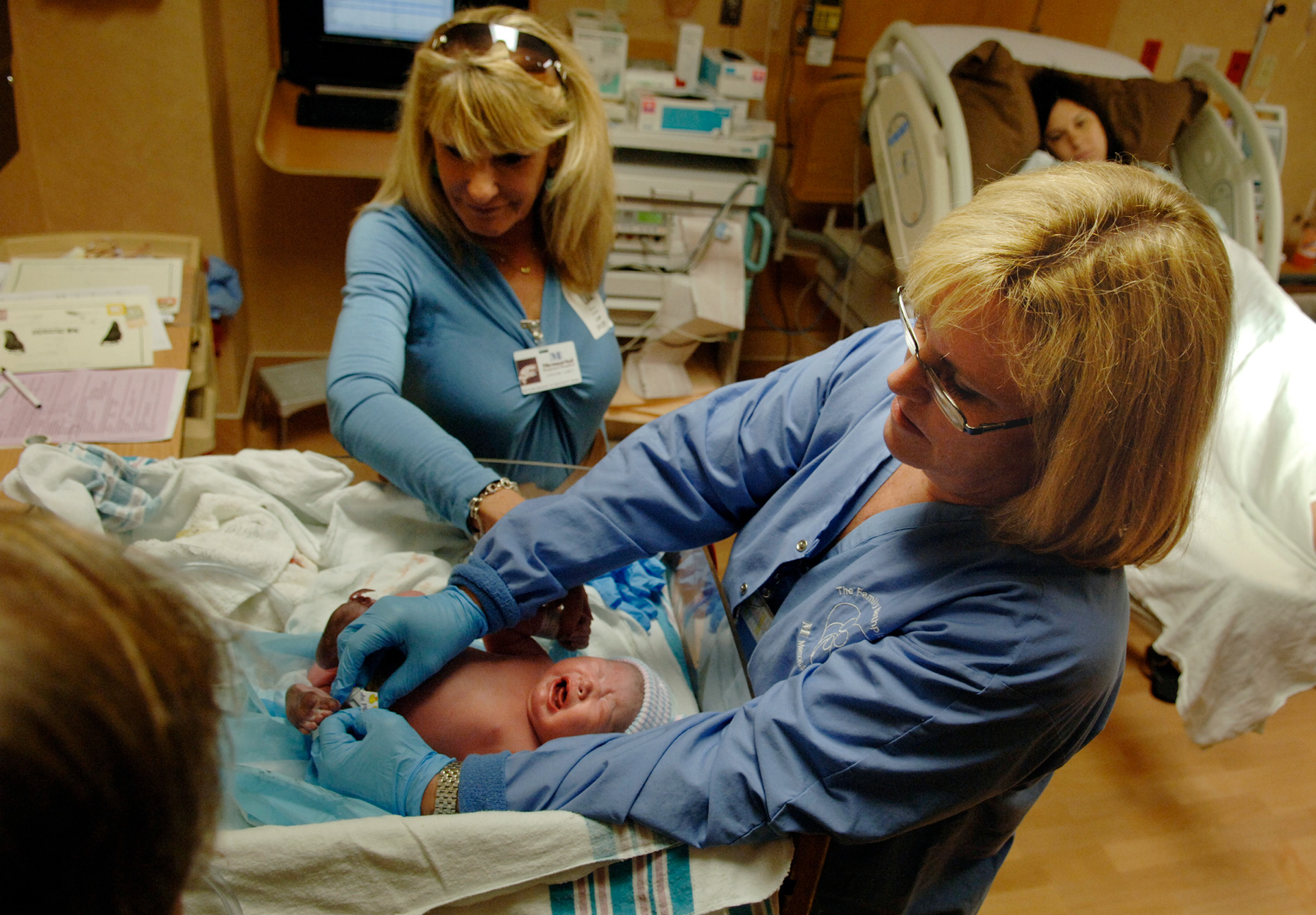 A labor and delivery nurse at Memorial Health in Hollywood, Fl. cares for a newborn as the family looks on.  In spite of high unemployment during the 2008 recession health care jobs remained a bright spot. 