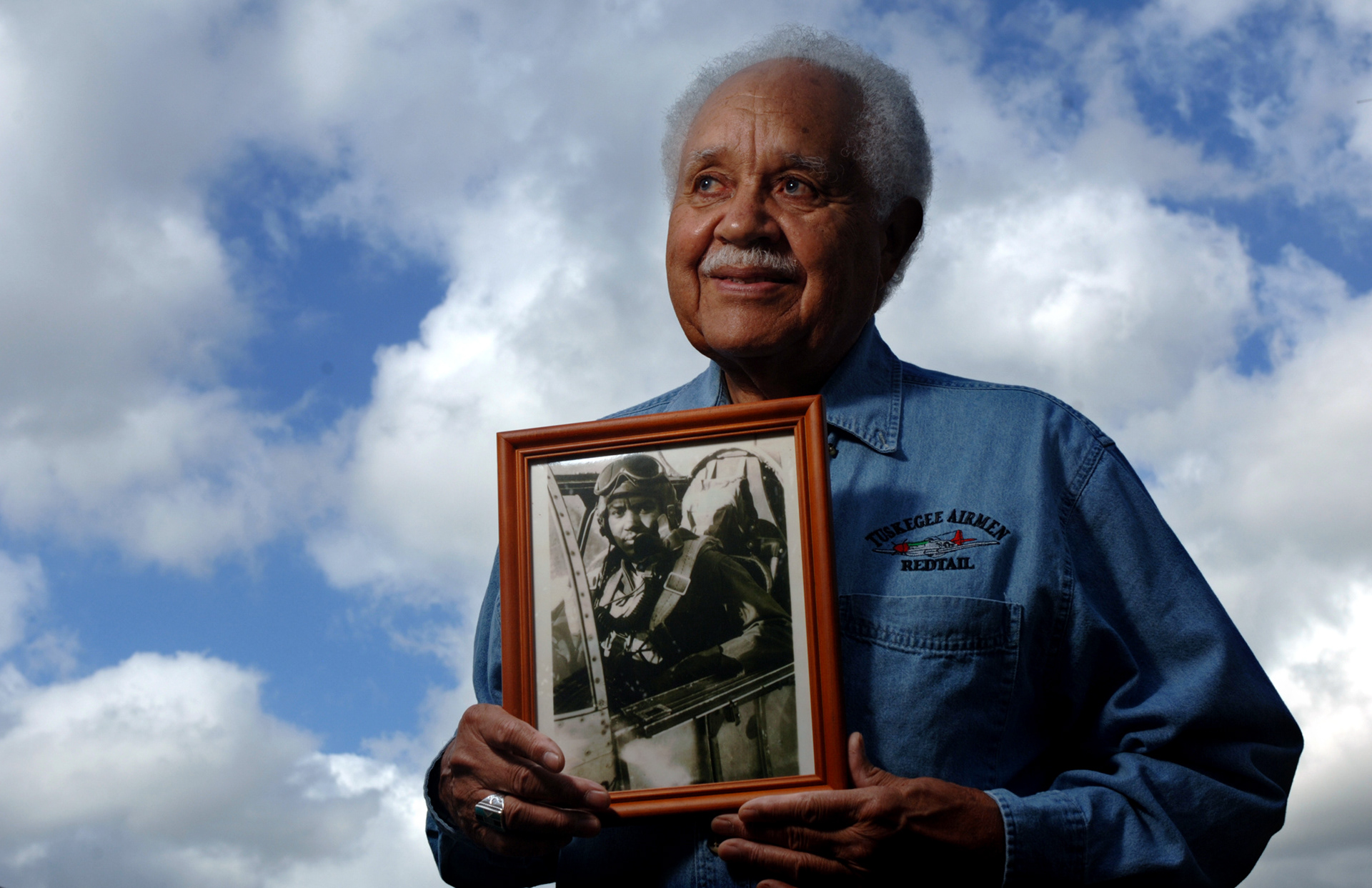 Retired Lt. Col. Leo Gray, 82, formerly a Tuskegee Airman, holds a 1945 photo of himself after flying a mission over Europe.  Gray was awarded the Congressional Gold Medal by President George W. Bush in 2007.