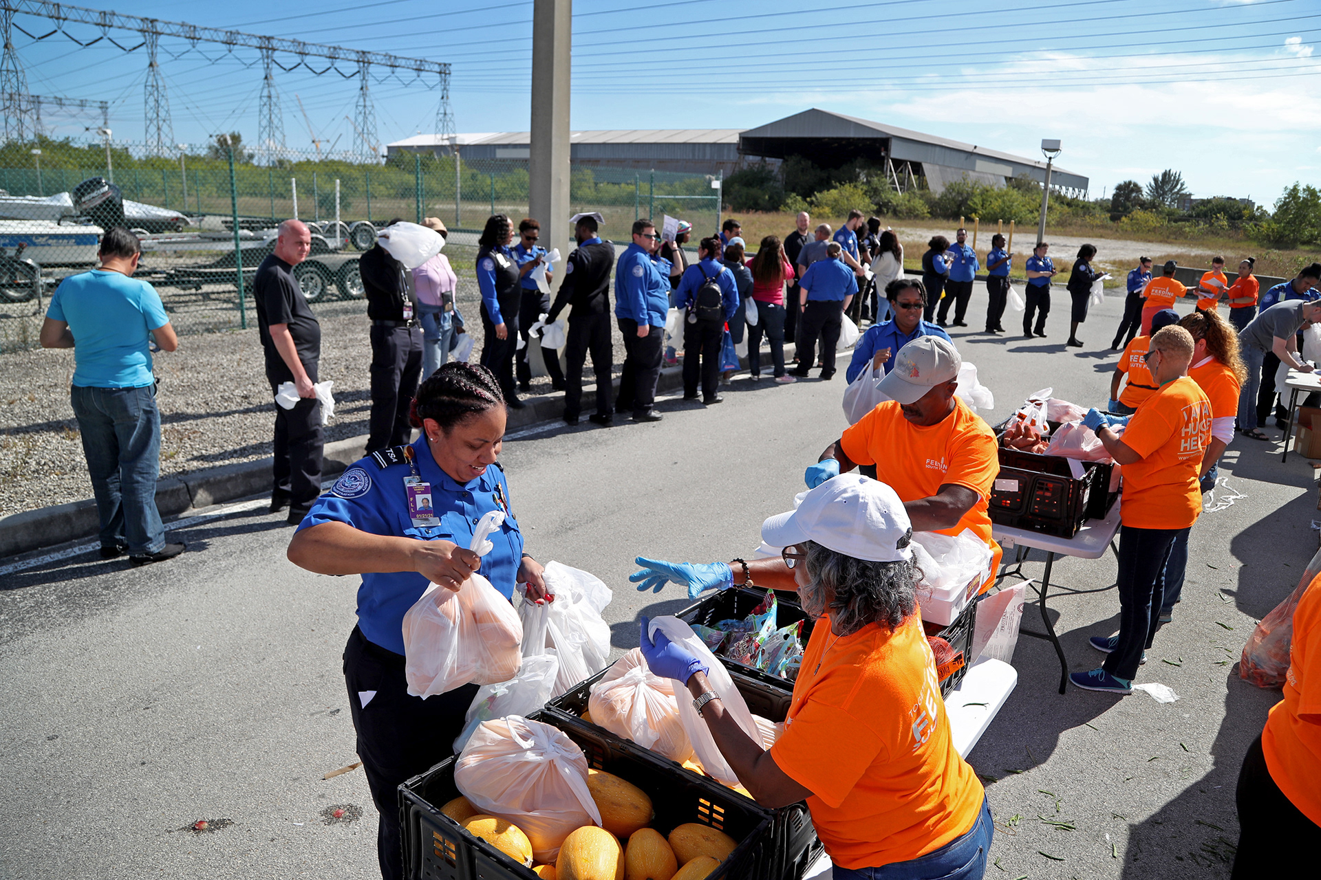 Unpaid TSA workers from Hollywood-Fort Lauderdale International Airport receive food from a relief agency in January 2019 during the government shutdown..