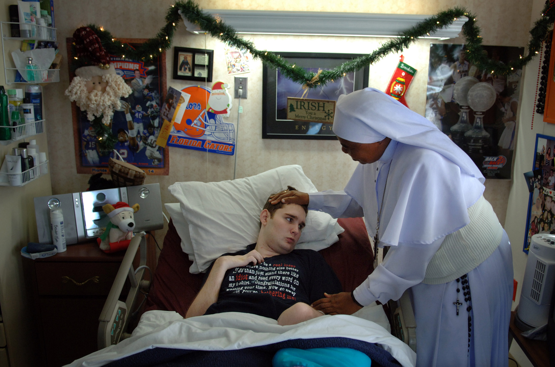 Brendan O'Toole, 21, who had been in a coma for 2 1/2 years after an auto accident, is visited by a nun at St. John's Nursing Center in Lauderdale Lakes., Fl.