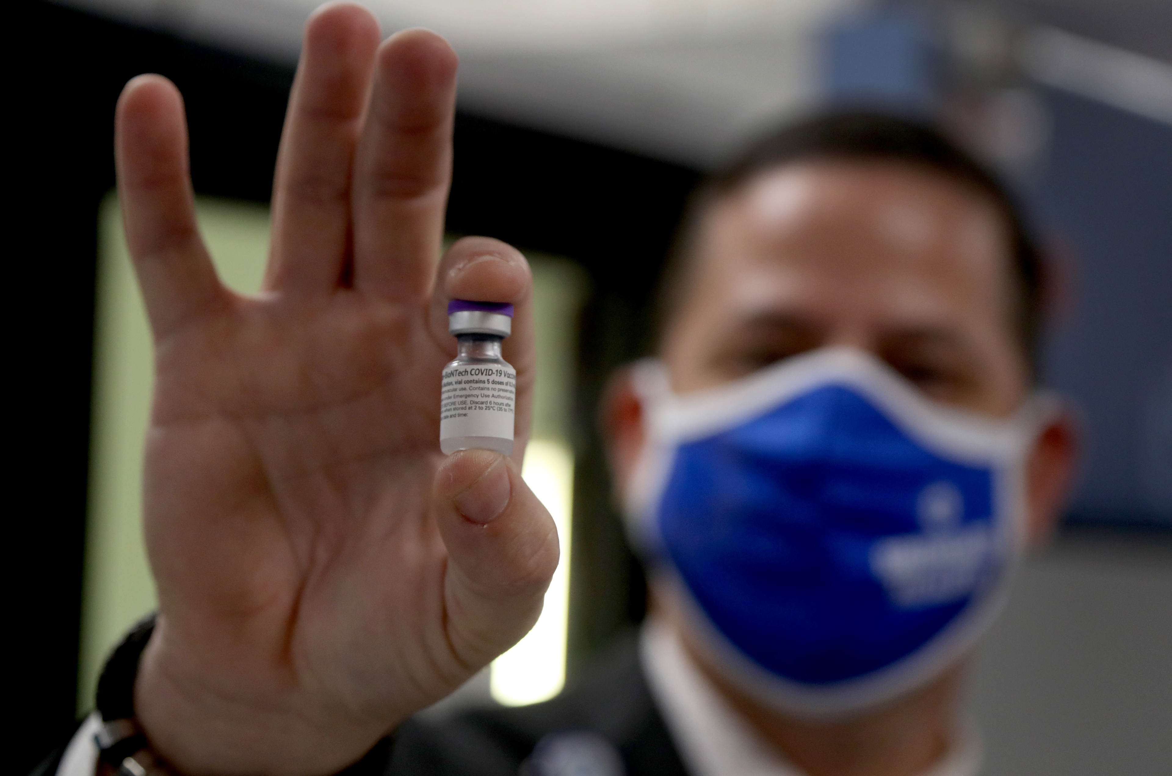 A pharmacy director for Broward Health in Fort Lauderdale, Fl. shows a vial of the Pzifer COVID-19 vaccine as the hospital receives it's first shipment of doses in December 2020. 