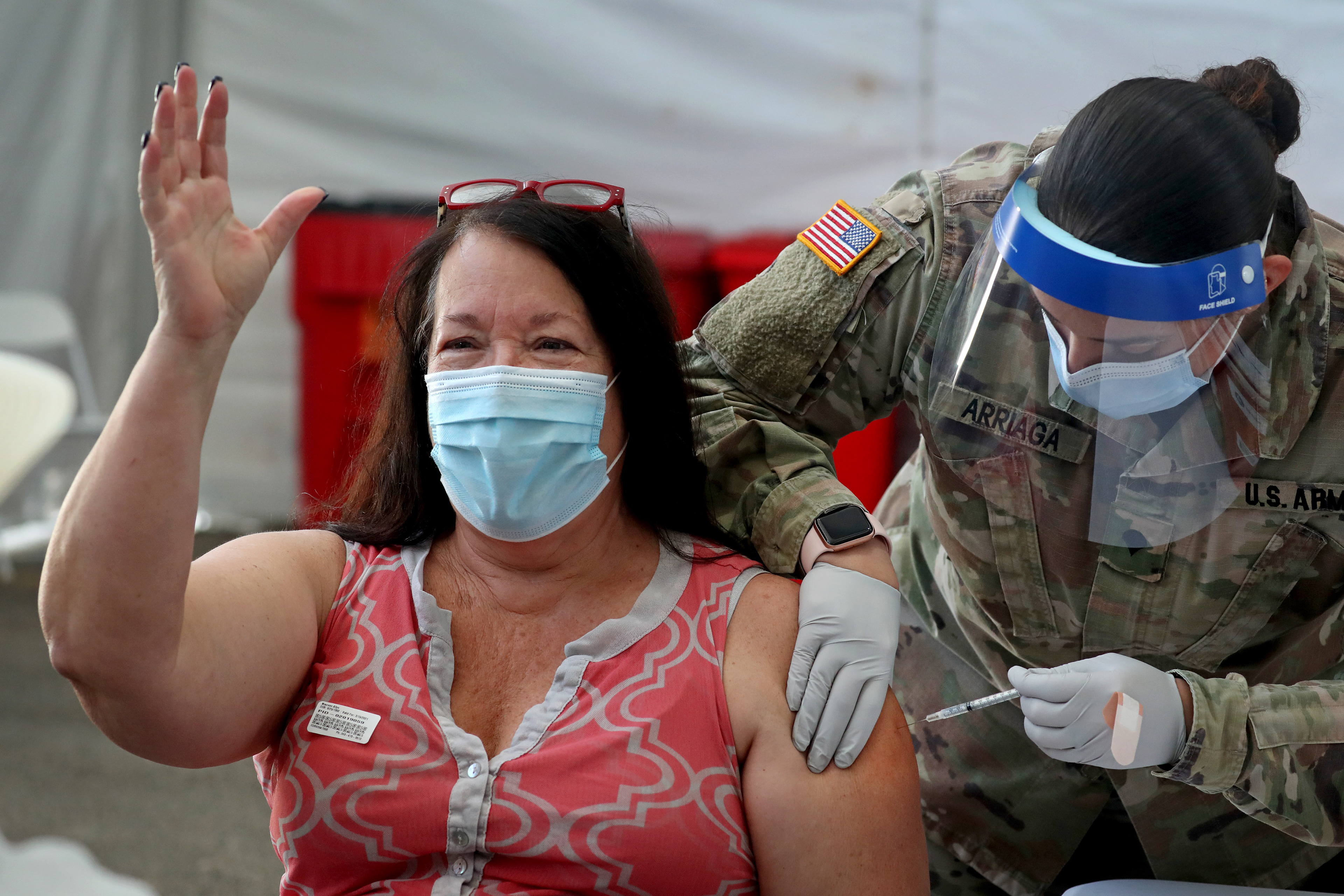 Maureen Allyn, 60, of Delray Beach, Fl. celebrates getting her first dose of the Pfizer COVID-19 vaccine at a FEMA-supported vaccine site in Miami in March 2021. 