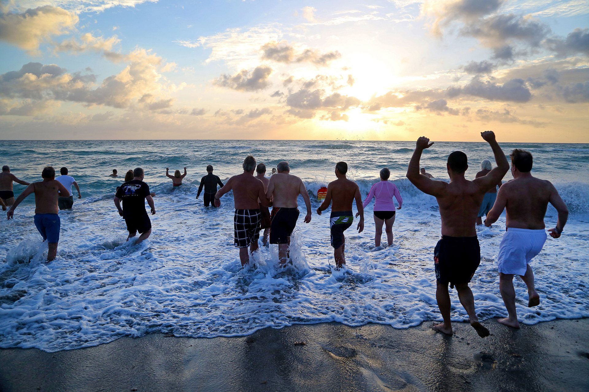Swimmers plunge into the ocean during Groundhog Day on Hollywood Beach in 2015.  The annual swim and dine event benefits Hollywood's Lifeguard Competition Team. 