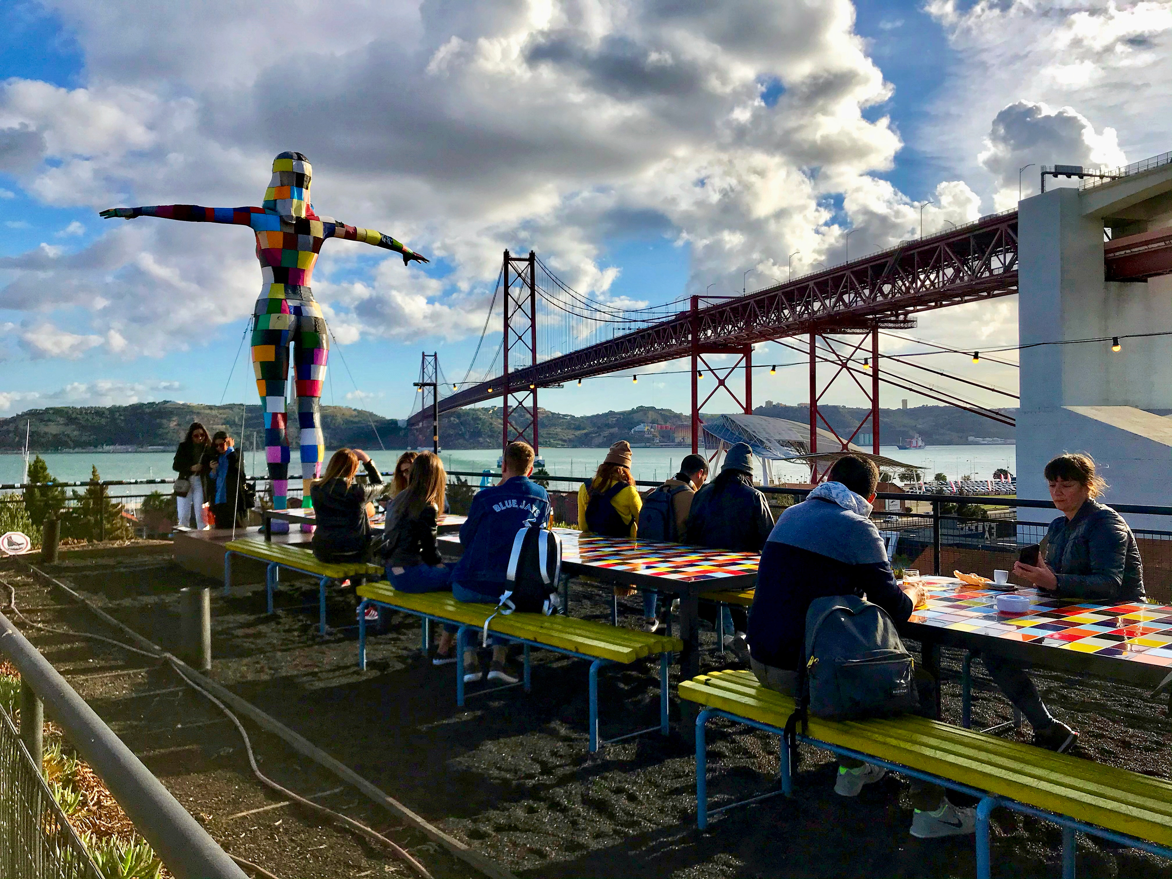 Bar patrons enjoy their food and drink in 2019 at the LX Factory, a popular entertainment area in Lisbon, Portugal.