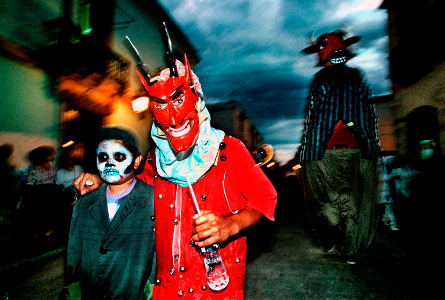 Revelers make their way through the streets of Oaxaca, Mexico as they celebrate Day of the Dead in 1997.