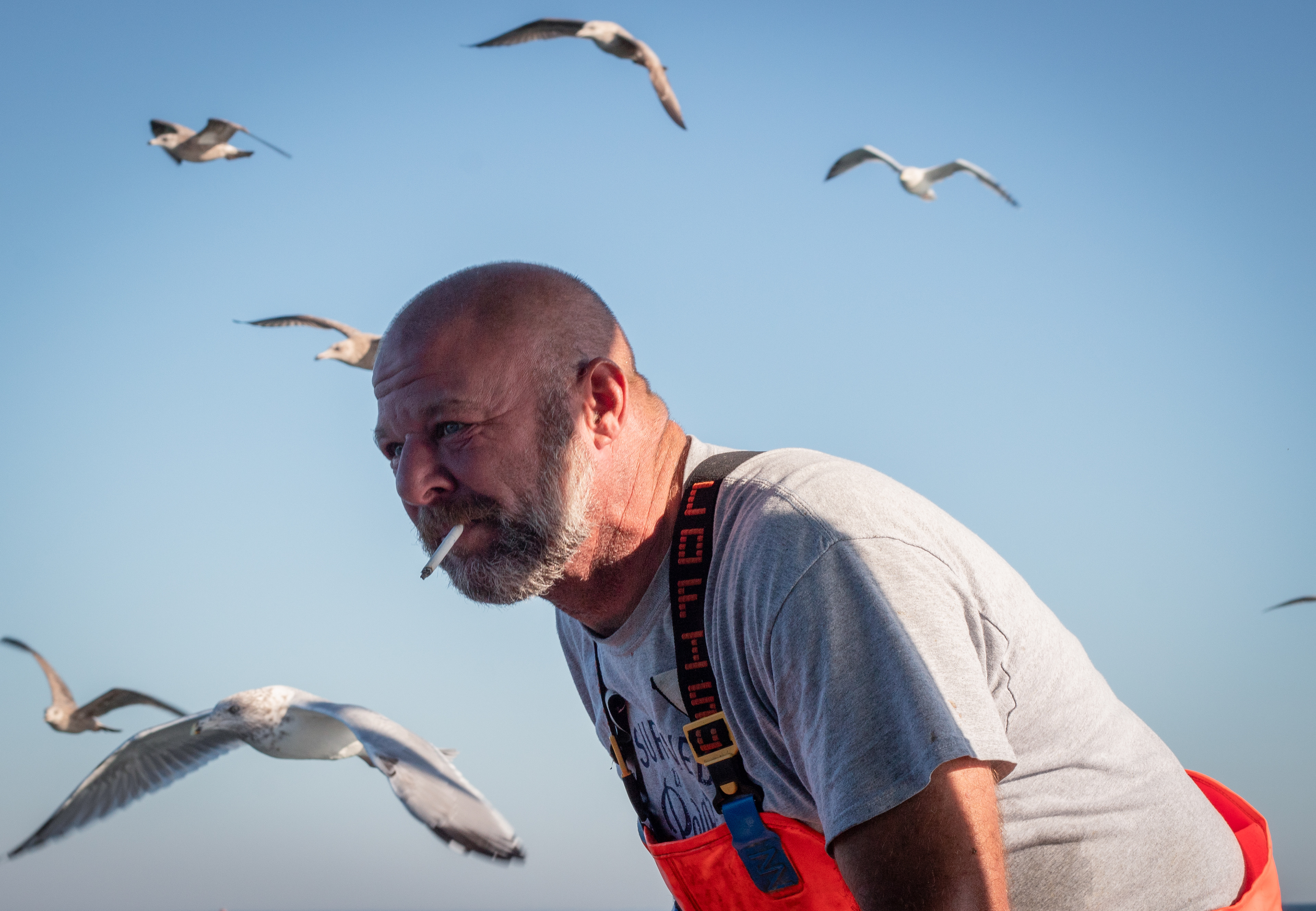 Boston — Massachusetts lobster fisherman Frank Lenardis, 49, smokes a cigarette aboard a lobster boat while fishing in late October, 2023.