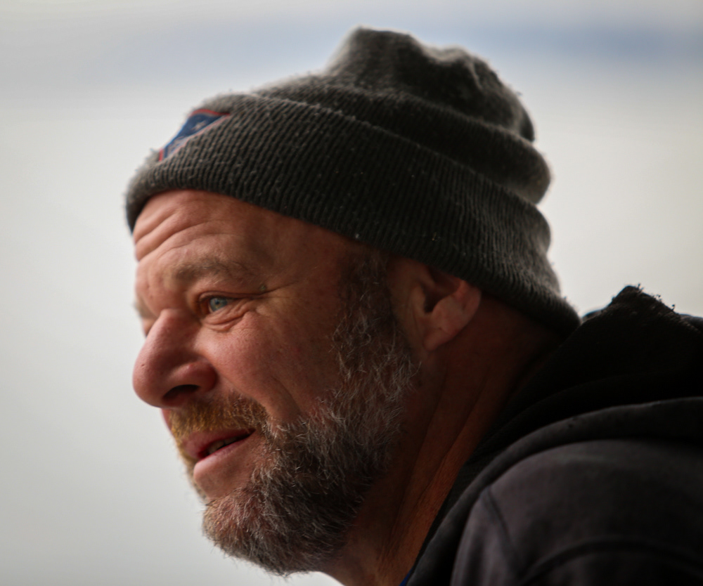 Frank Lenardis, 49, aboard his fishing partner's lobster boat on a cold December morning on the Boston Harbor. Lenardis has fished with Steve Holler for about 20 years, and makes just $1 for every lobster trap he helps pull from the sea floor. 