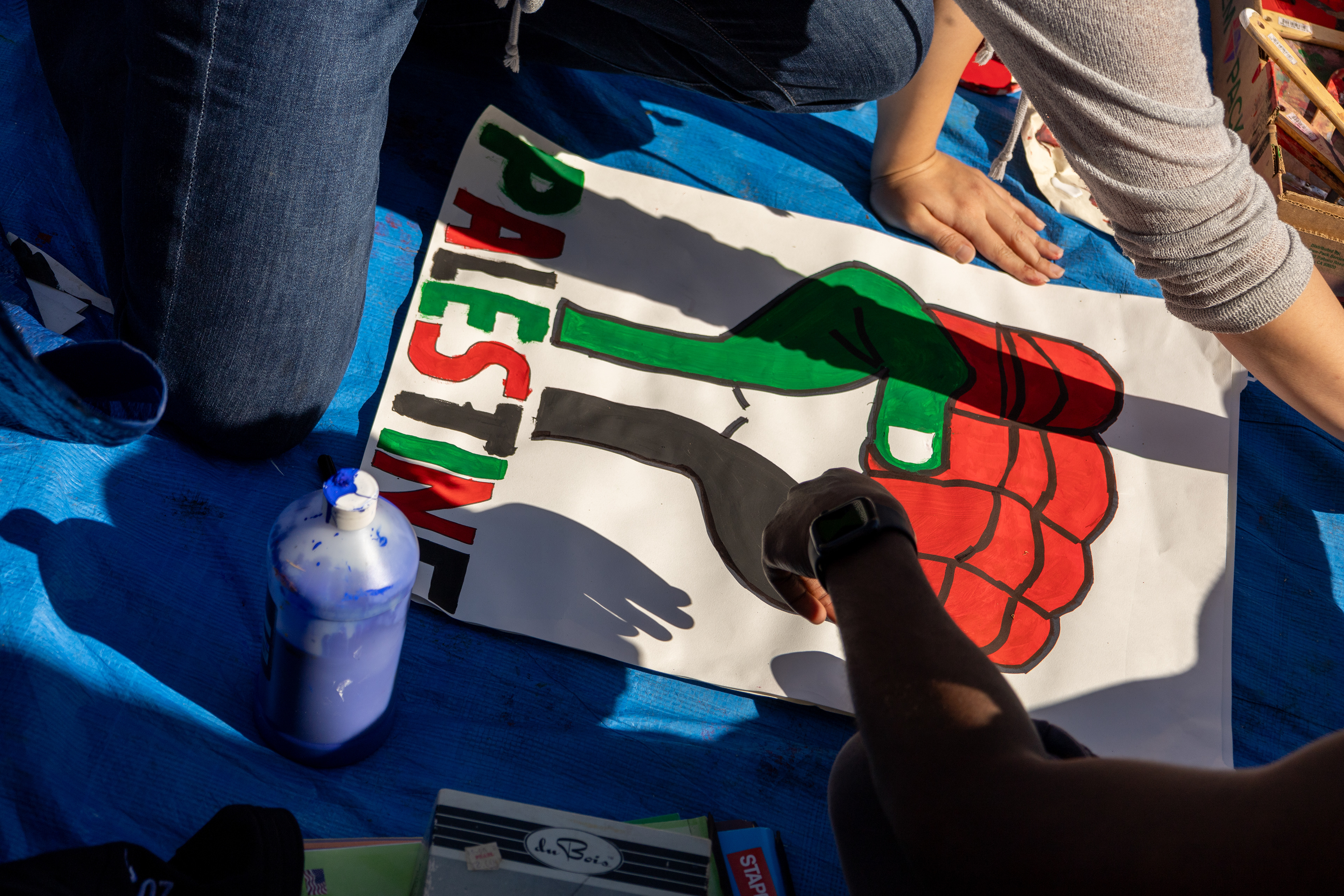 Cambridge, Mass. — Protesters make signs inside M.I.T.'s encampment protesting M.I.T.'s connections to the Israeli government.