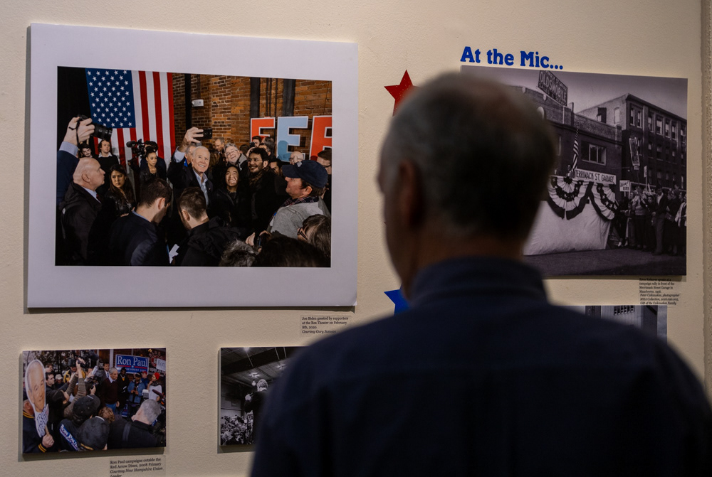 Manchester, N.H. — A Dean Phillips supporter looks at a photo of president Joe Biden on the wall of the Millyard Museum in Manchester, N.H.