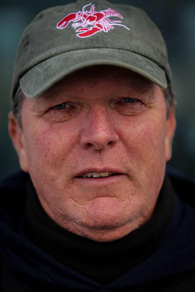 Steve Holler, 61, poses for a portrait while aboard his lobster boat, November Gale. Holler has fished for lobsters in the Boston Harbor for nearly 50 years, but faces increasing struggles to maintain his livelihood.
