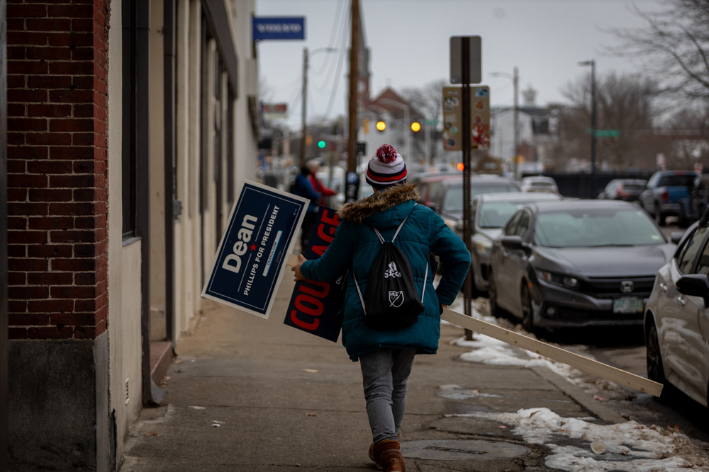 Manchester, N.H. — A supporter of long-shot Democratic candidate Dean Phillips (D-Minn.) holds a Dean Phillips for president sign walking down the street in Manchester, New Hampshire.