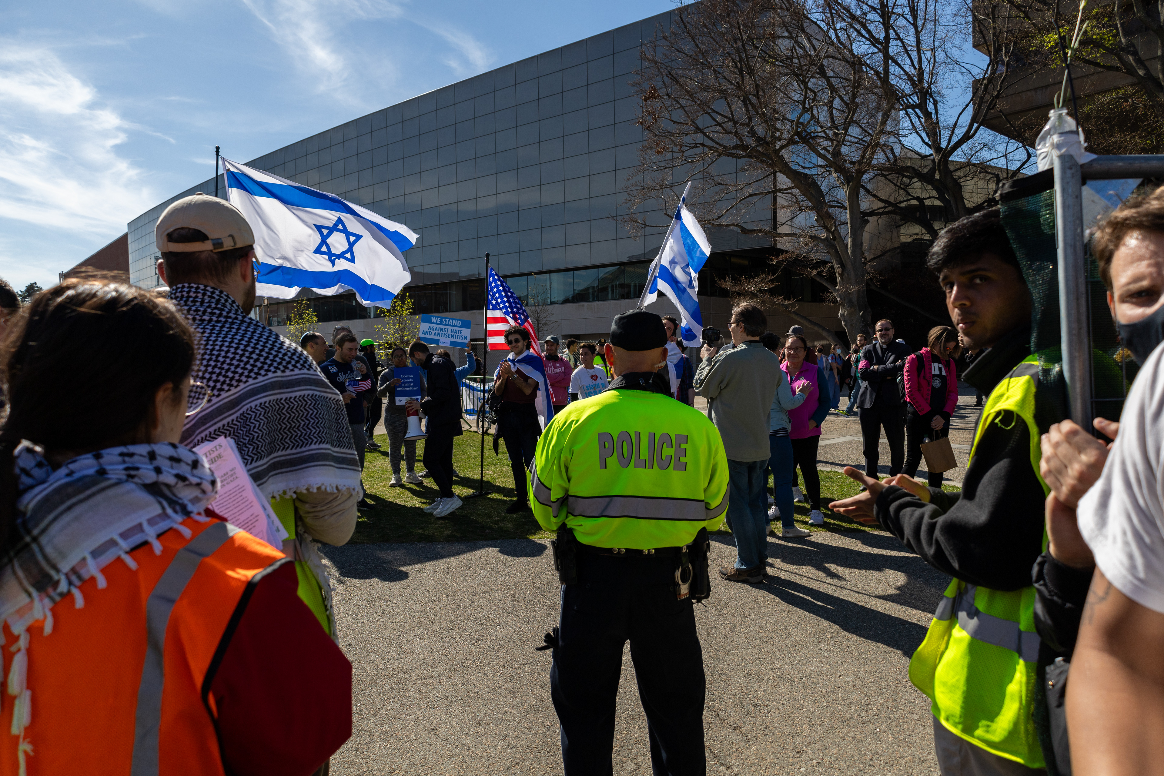 Cambridge, Mass. — A police officer watches as Israeli counter protesters confront pro-Palestine protesters at M.I.T.
