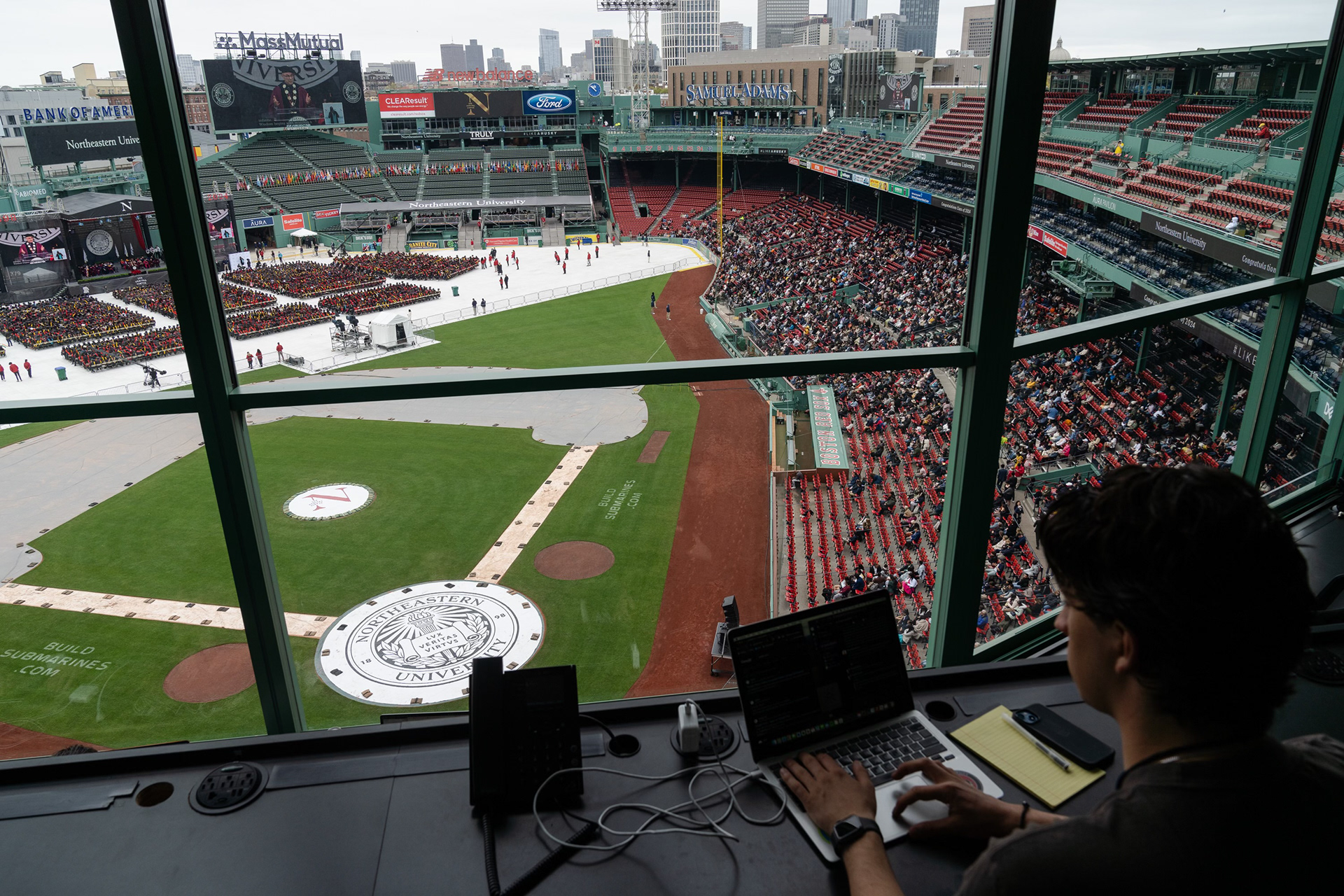 Matthew covering Northeastern University's commencement ceremony at Fenway Park for the New York Times. Photo by Sophie Park.