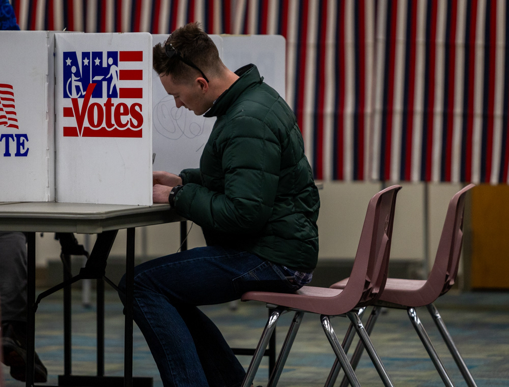 Manchester, N.H. — A voter fills out a paper ballot at a polling location in Manchester, N.H.
