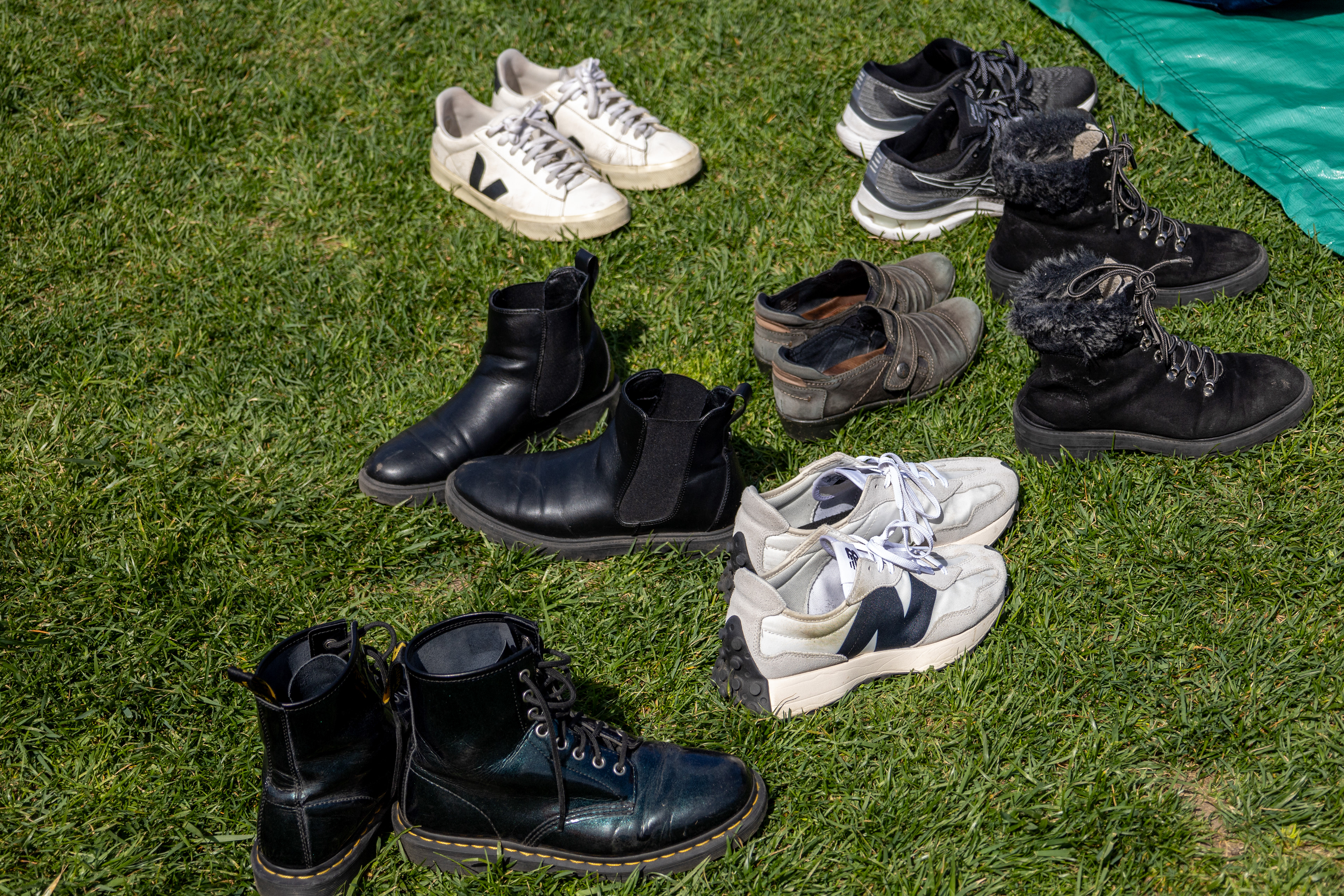 Cambridge, Mass. — Shoes sit along the side of a tarp where protesters gathered for a prayer inside M.I.T's encampment protesting the university's involvement with the Israeli government.