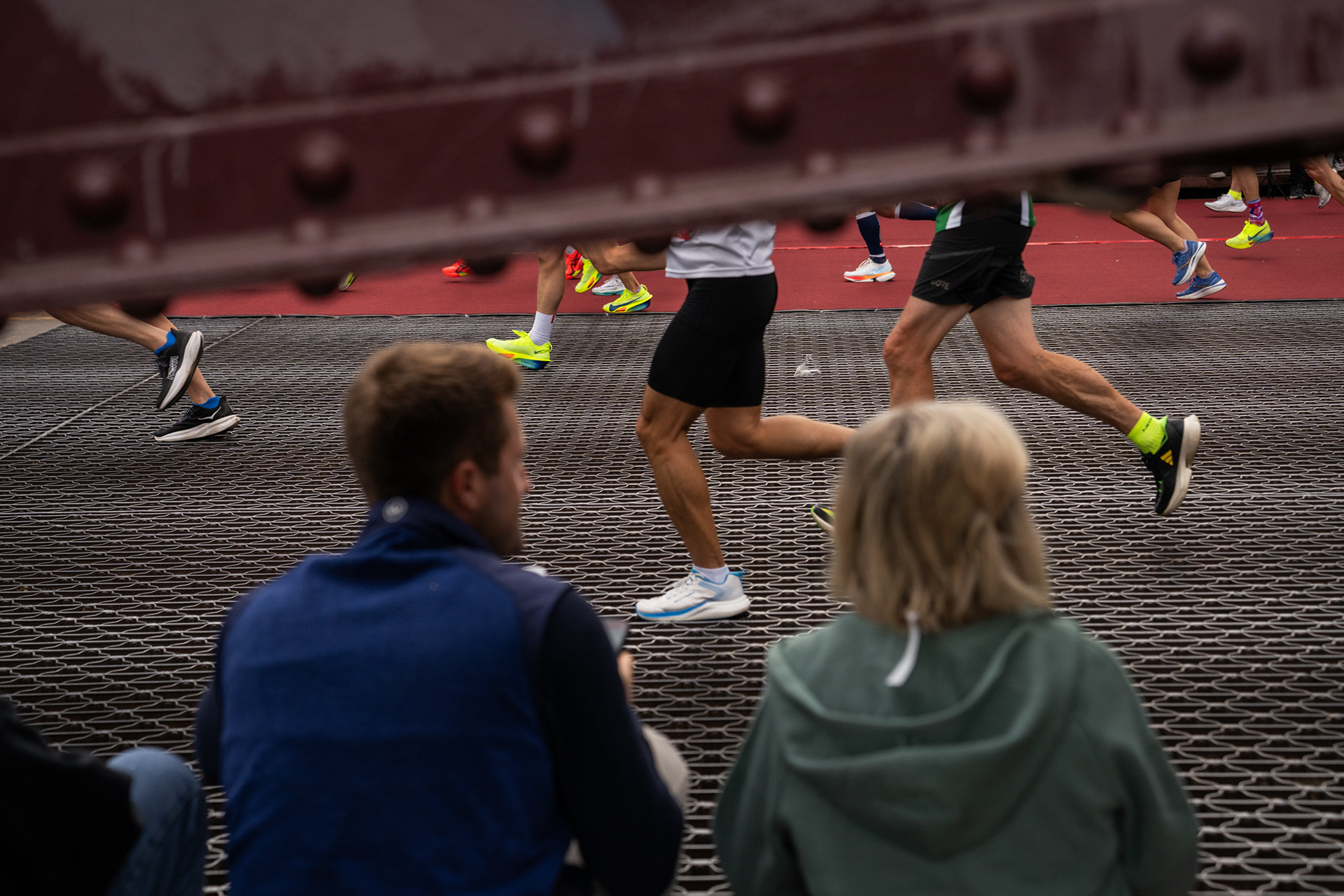 Spectators sit on LaSalle St. bridge as runners head out of the Loop and into River North in the Chicago Marathon. 