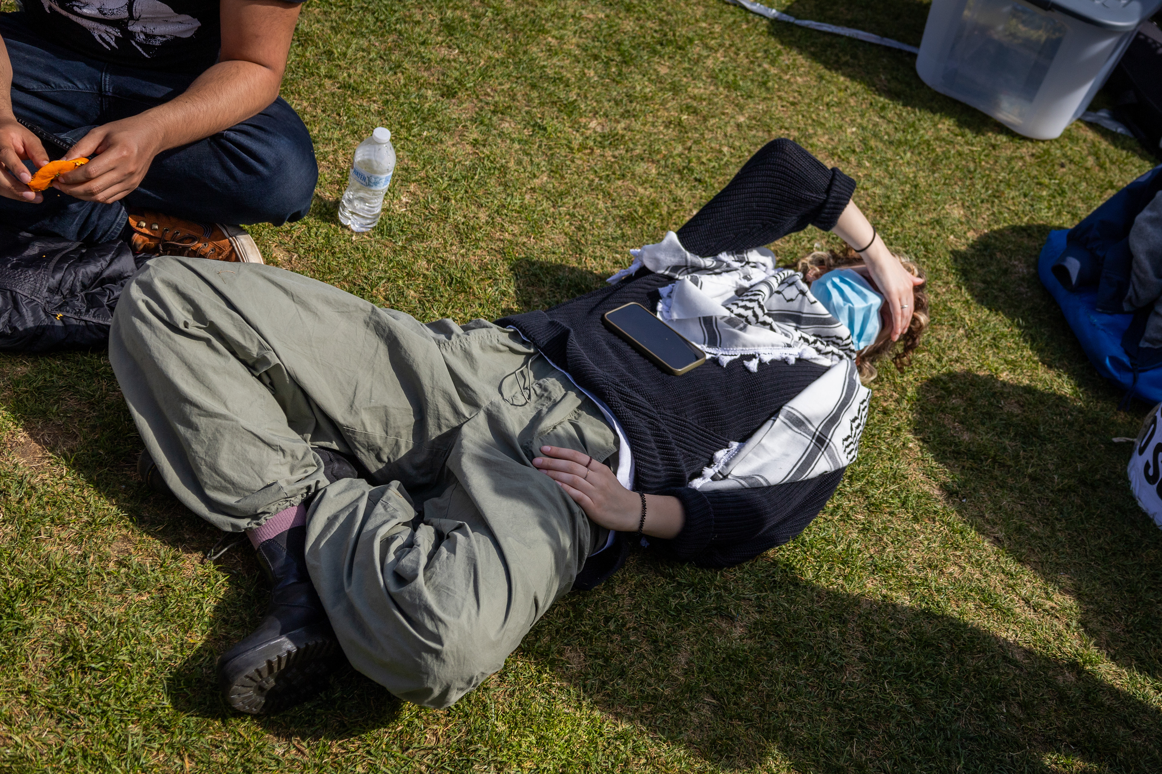 Cambridge, Mass. — A protester rests in the sun in M.I.T.'s "scientists against genocide" encampment, May 3, 2024.