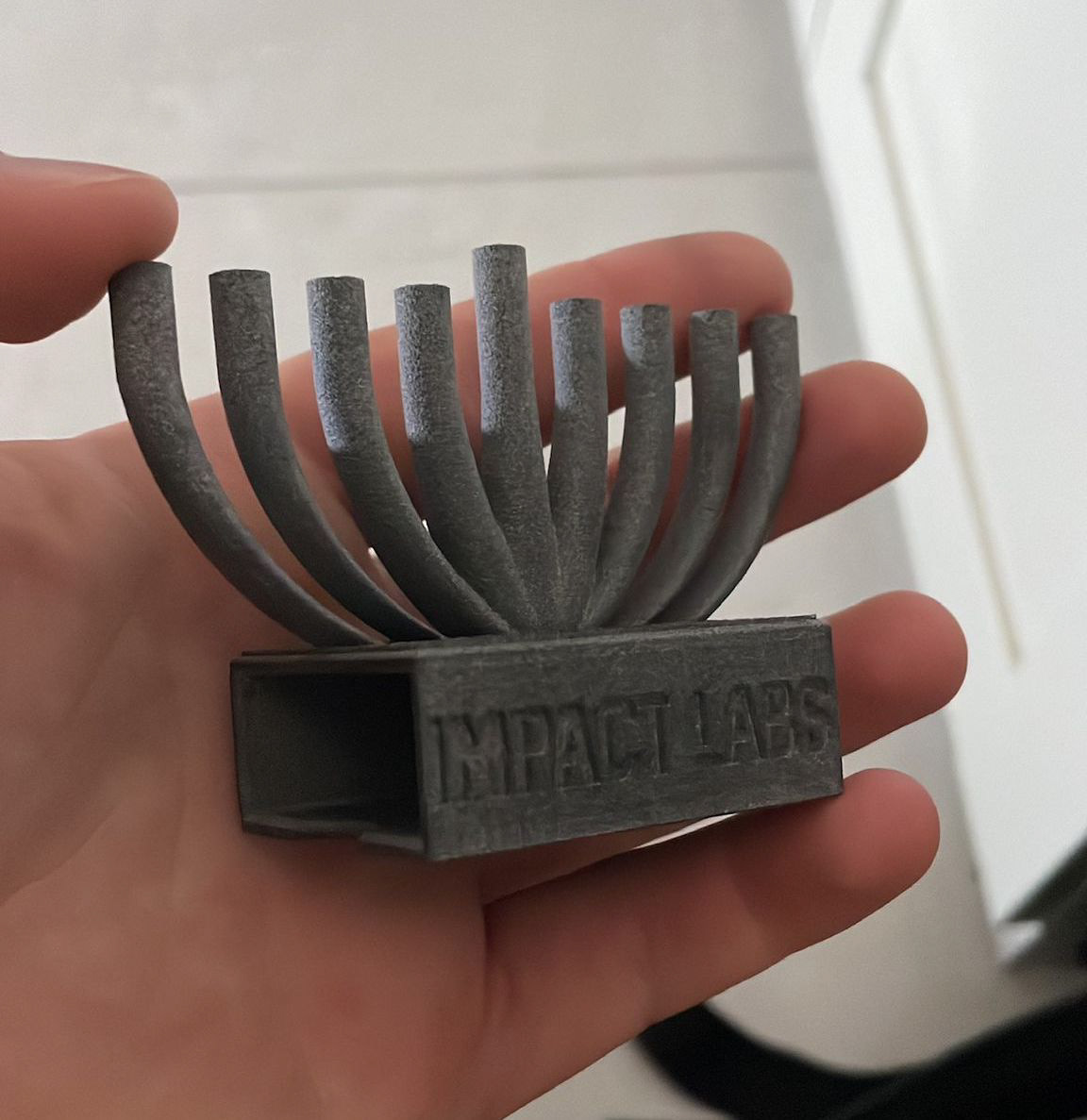 A mini menorah that slides over a matchbox and uses matches instead of candles. It was included as a freebie in customer orders.
