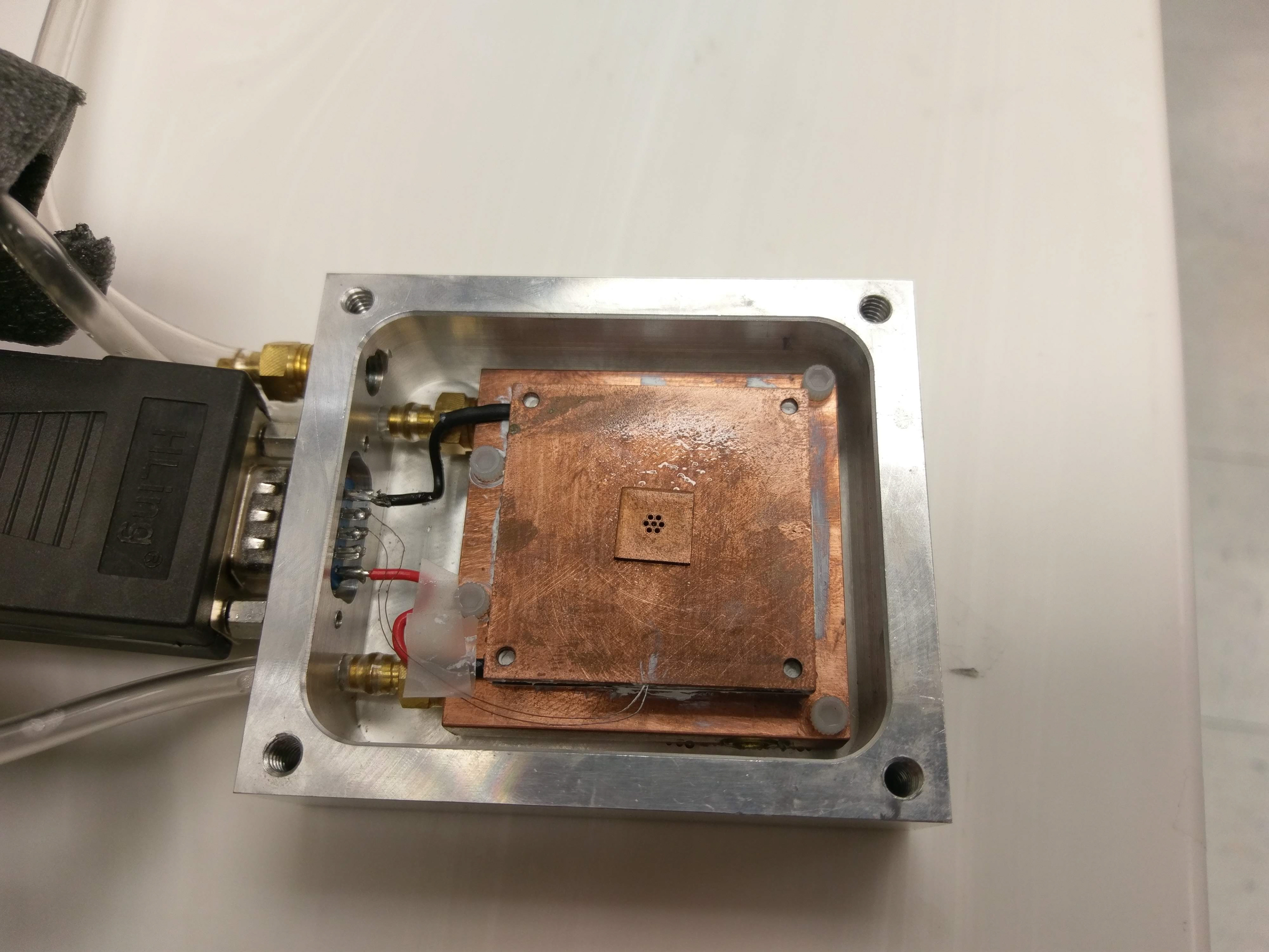 Picture of the cold-stage. Those tiny holes in the center are where I carefully pipetted in samples before running freezing experiments.