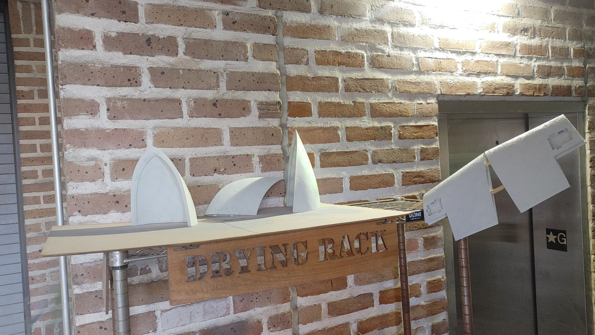 Parts drying on a rack after being treated with Flex Seal