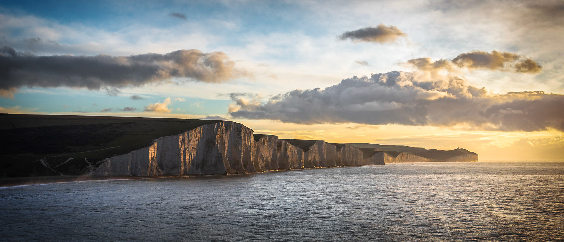 Golden light hits the cliffs at Cuckmere Haven shortly after a December dawn.