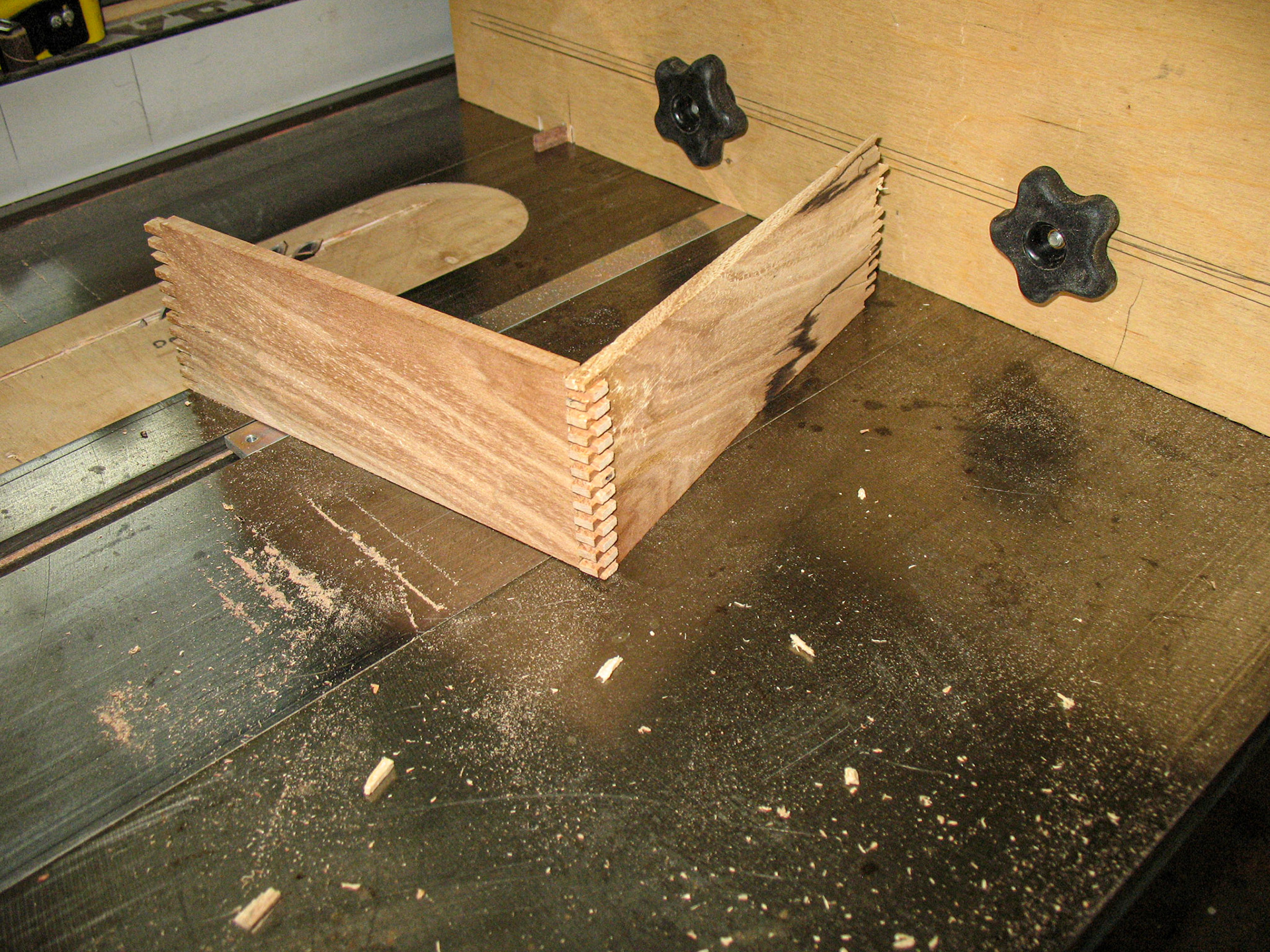 An experiment with finger joints.  Notice the broken "fingers" scattered across the table top.  I guess I need to space them farther apart.