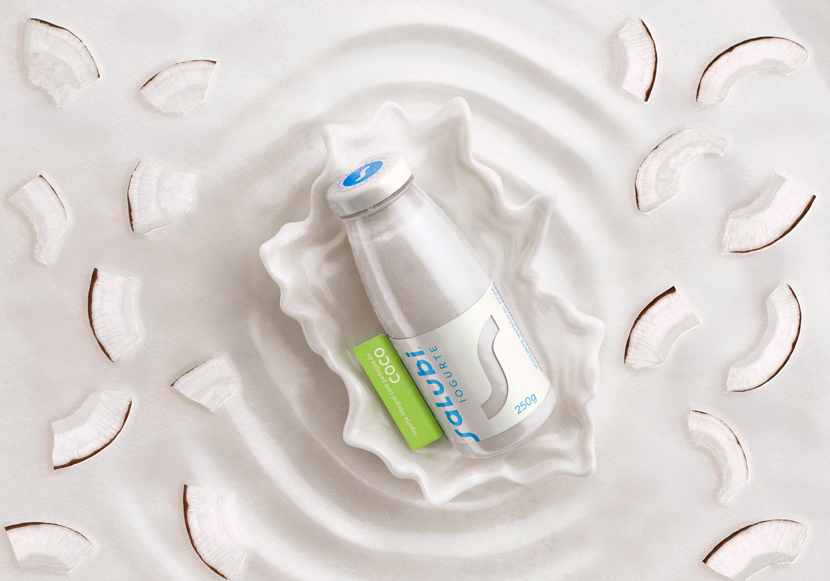 a cgi key visual of a yogurt on a creamy background with coconut pieces