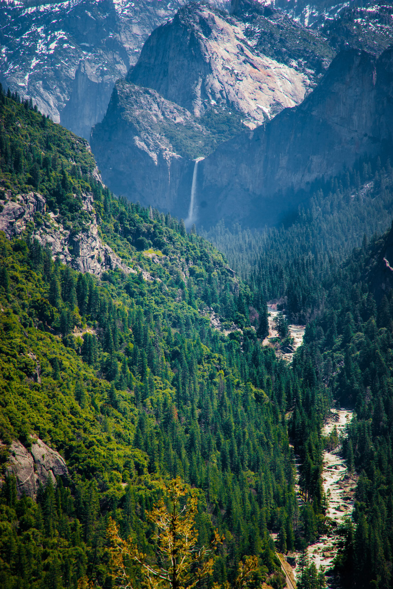 Driving down into the  Yosemite valley with the view of Bridal Veil Falls and the Merced River.