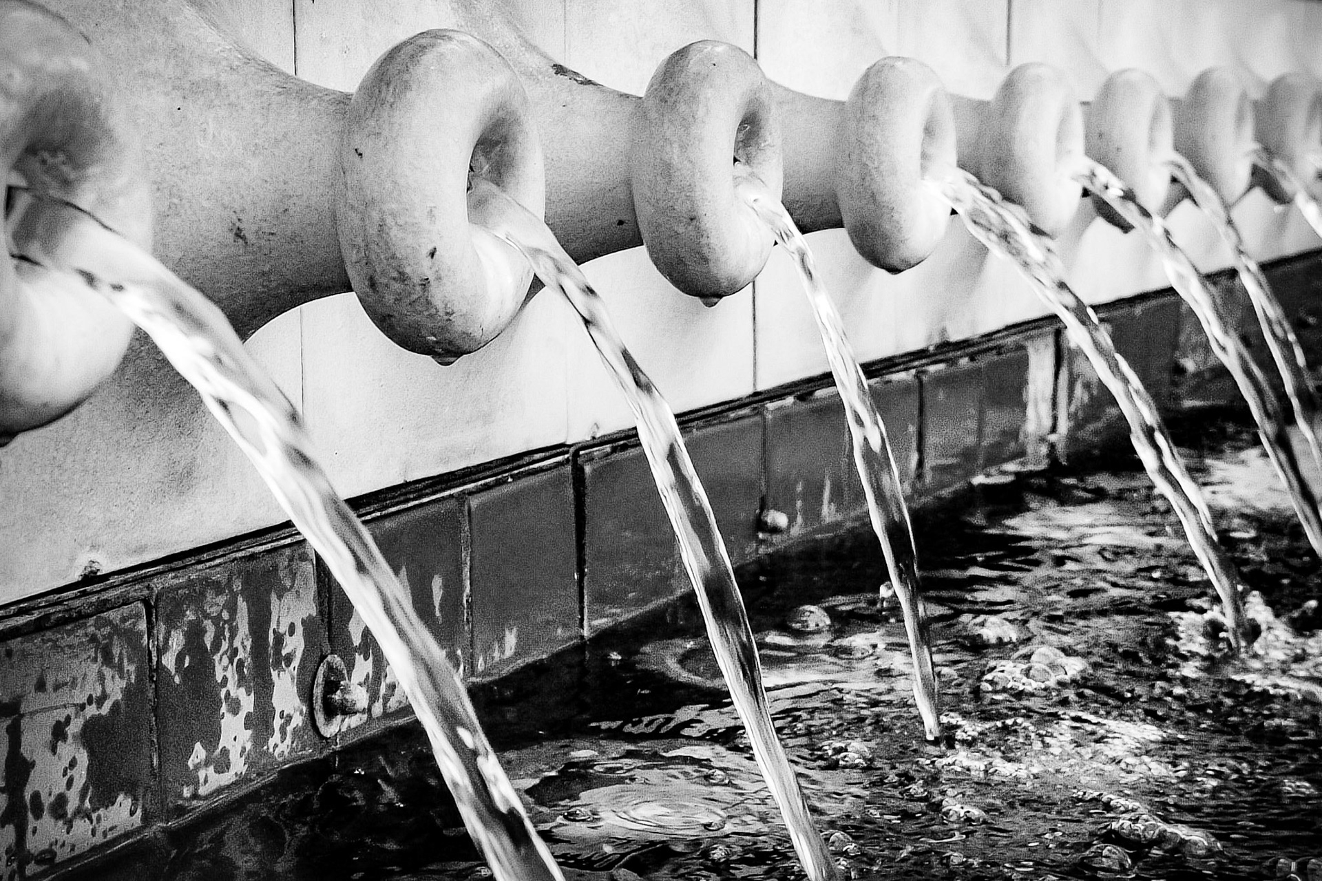 These are a series of jar like spouts that run along the side of a fountain in the plaza off of Biscayne Avenue in Miami.