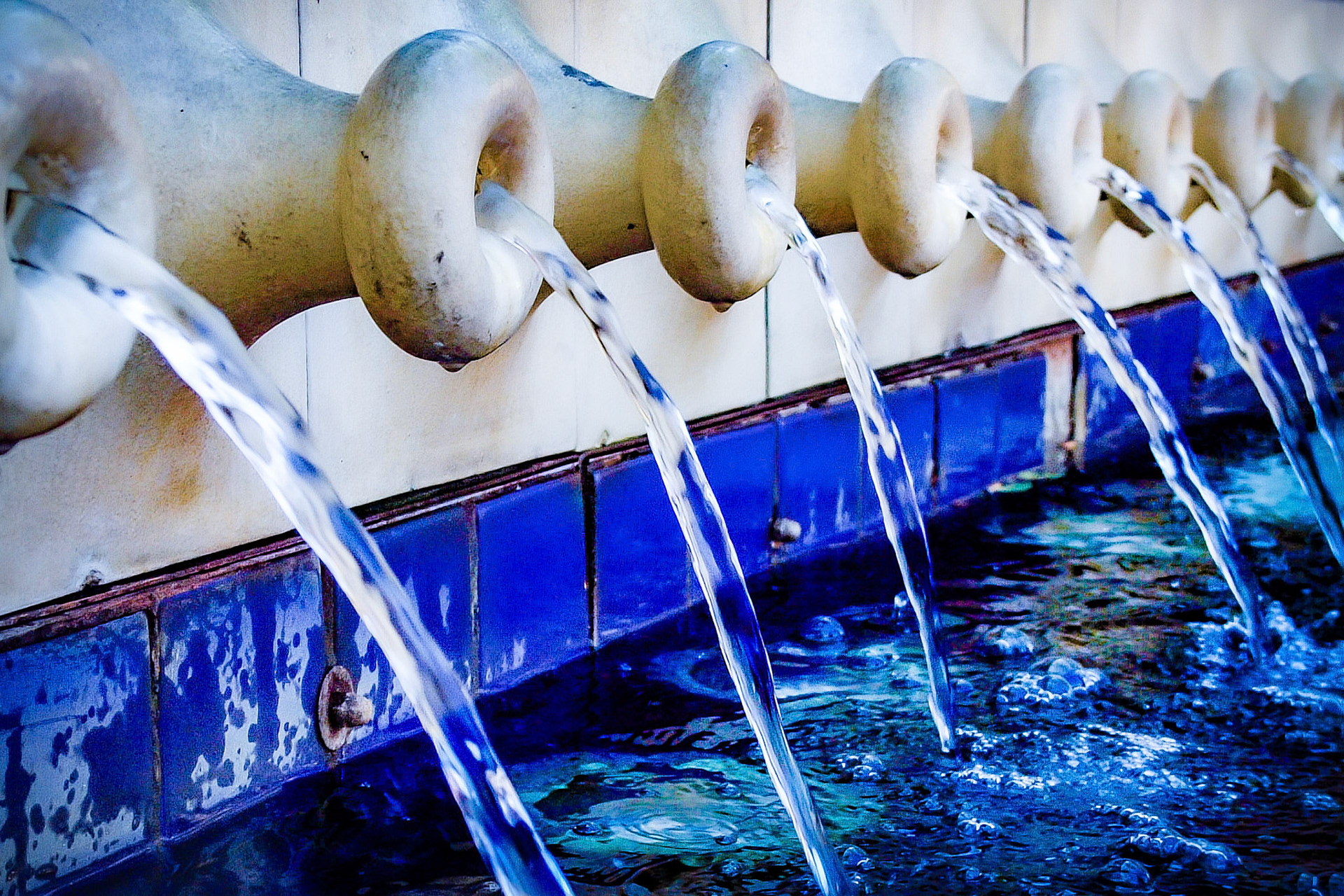 These are a series of jar like spouts that run along the side of a fountain in the plaza off of Biscayne Avenue in Miami.