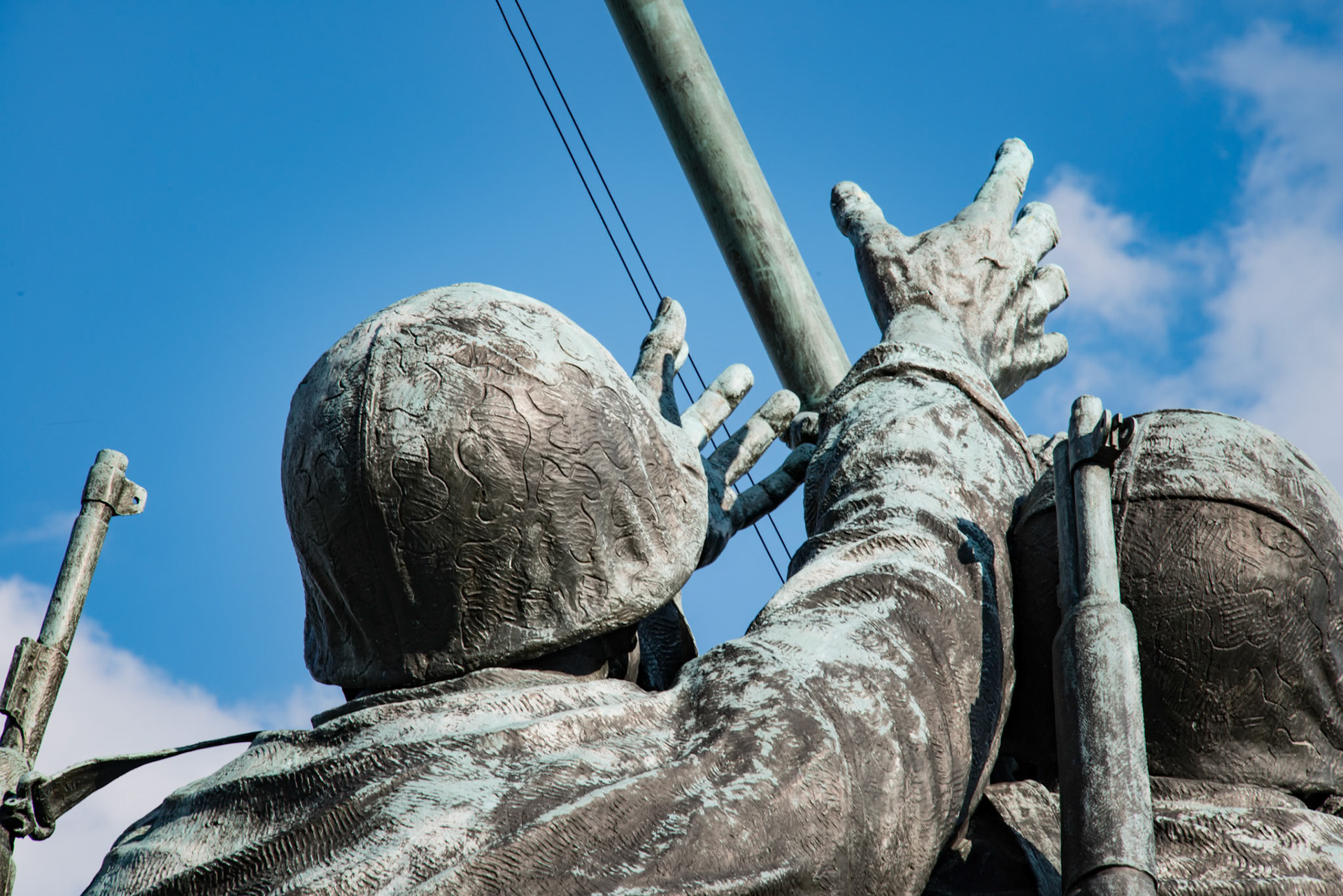 Hands reaching out for the flag at Iowa Jima