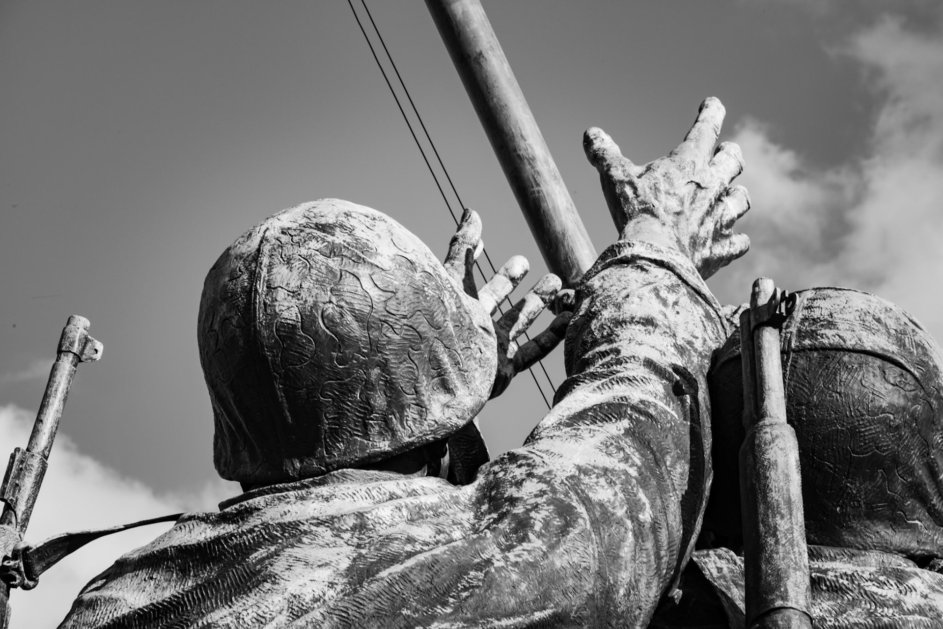 Hands reaching out for the flag at Iowa Jima