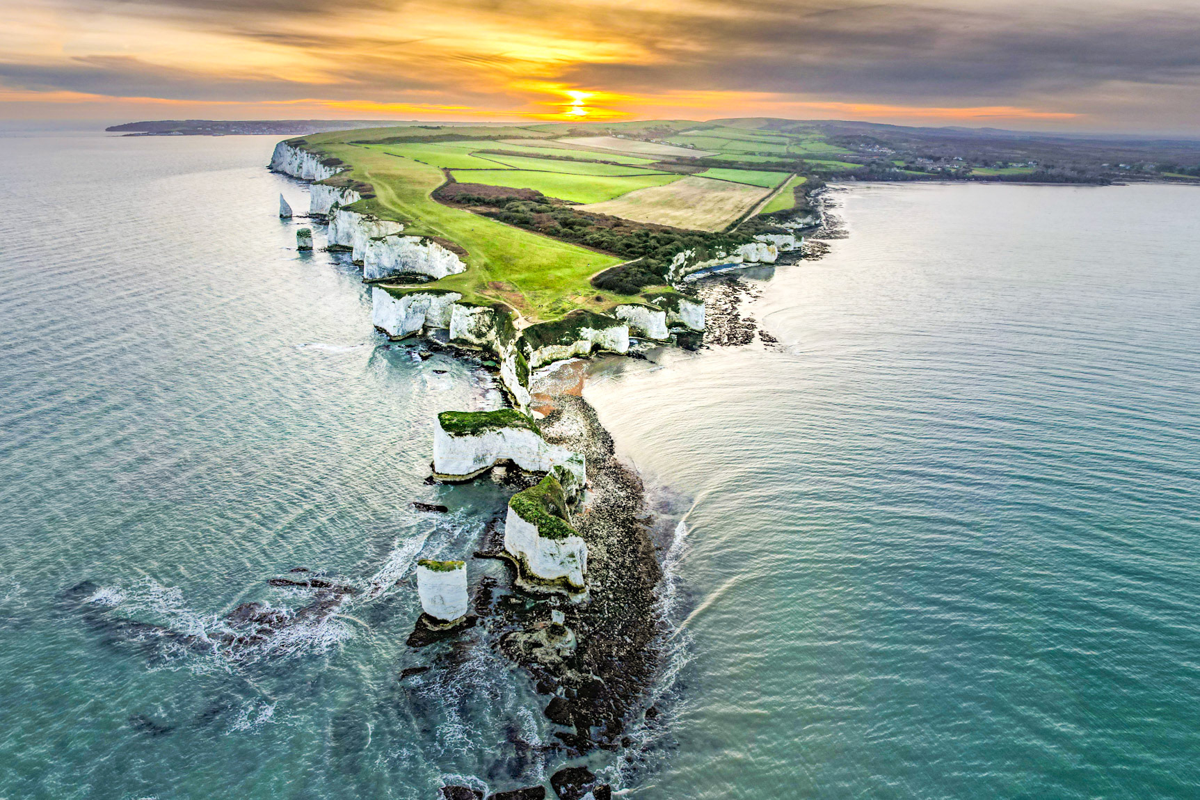 Old Harry's Rocks, Dorset, UK, from above. Sunset aligns with the rock formations.