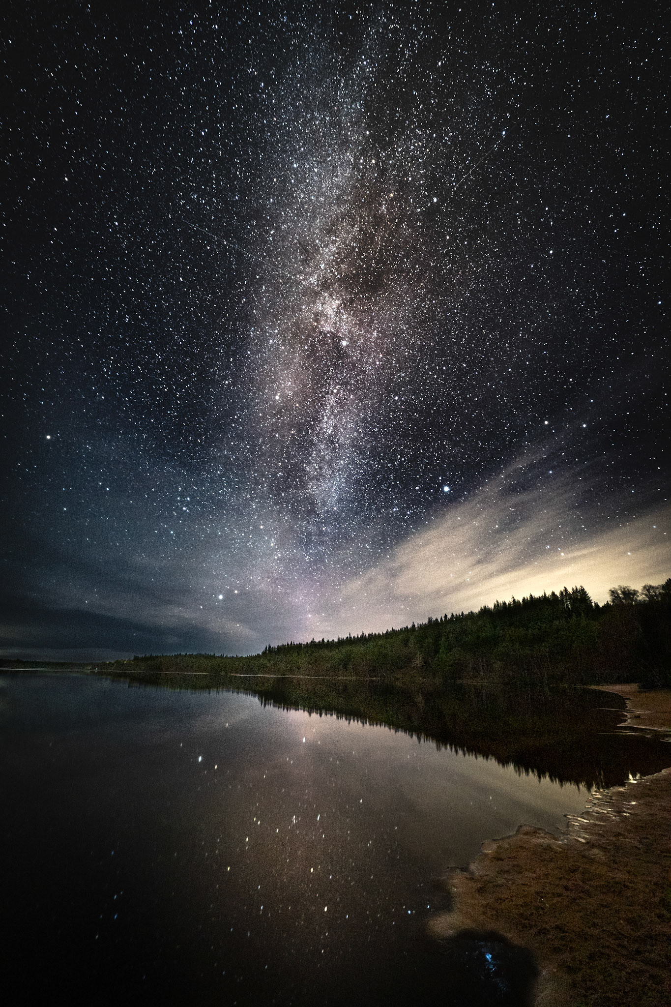 The Milky Way clearly visible from the beach of Loch Morlich, Cairngorms, Scotland