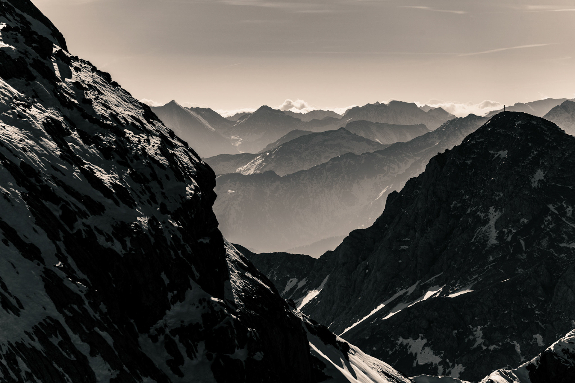 Layers of distant mountains visible in this Austrian alpine scene. Black and White