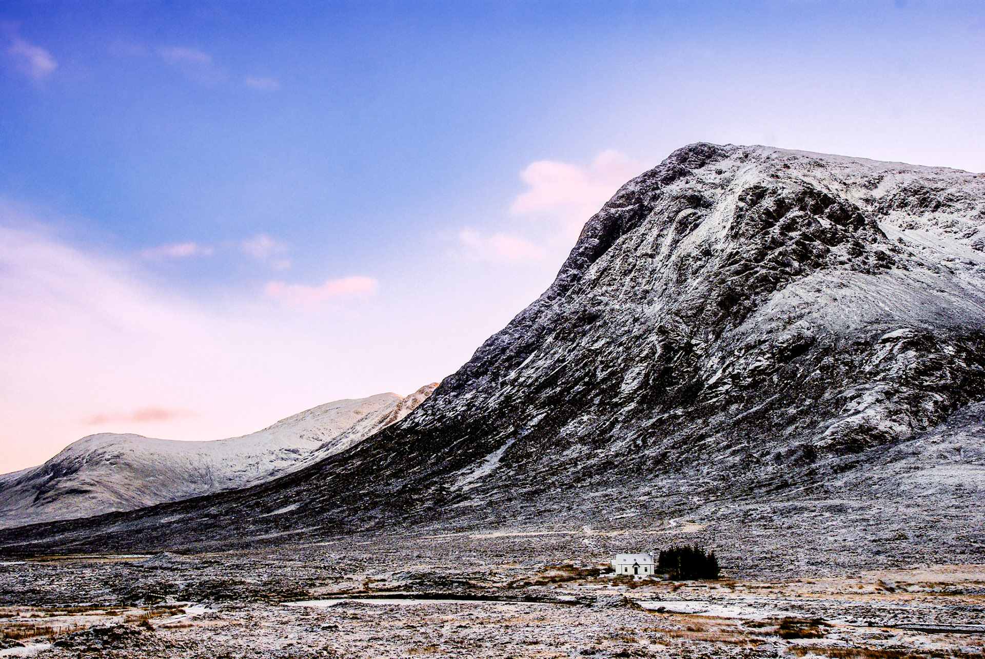 White Cottage of Glencoe on a frosty and snowy winter day, Scotland