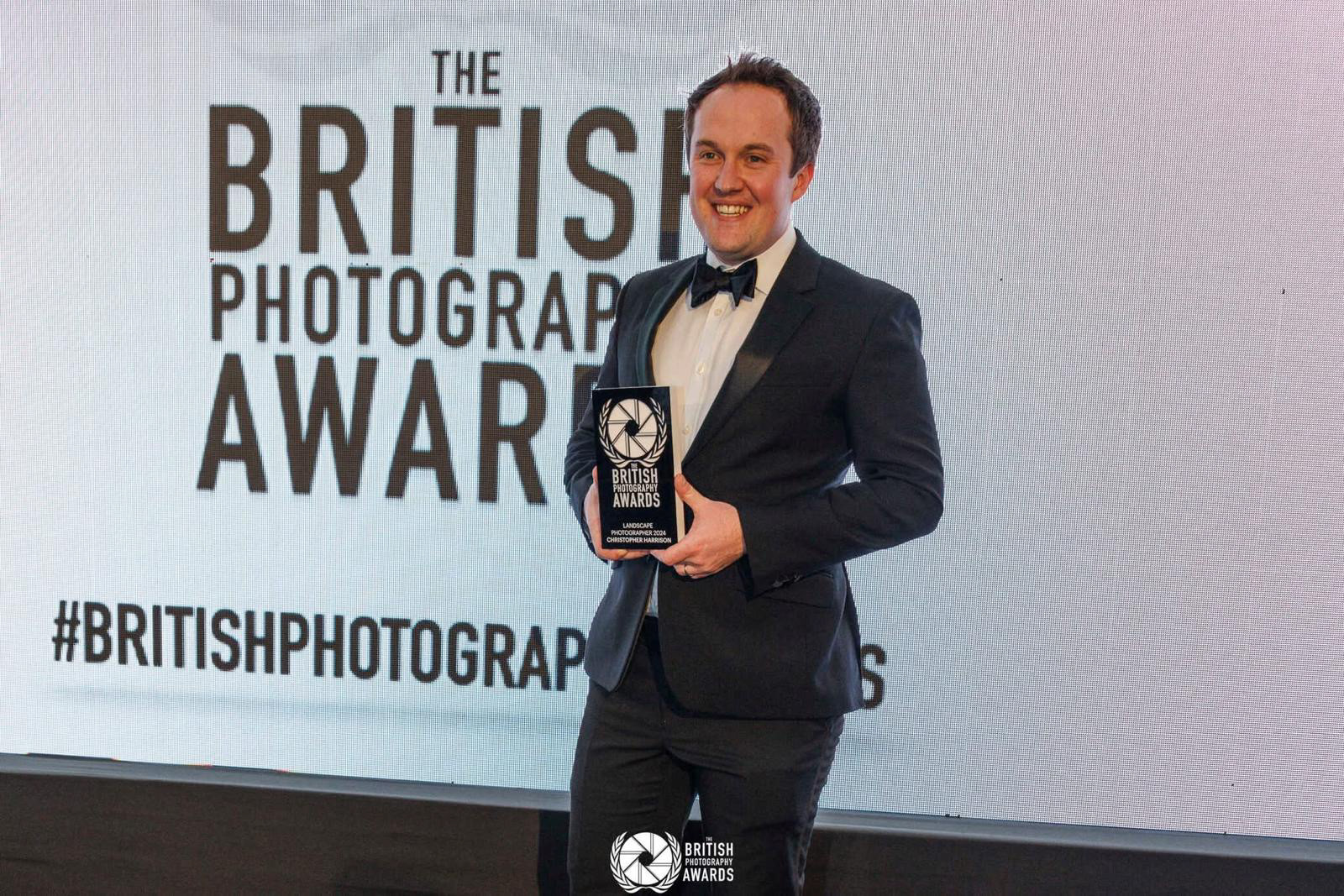 Christopher Harrison at the British Photography Awards in London, with his winning trophy from the Landscape Category where his image Bluebells at Sunrise won. 