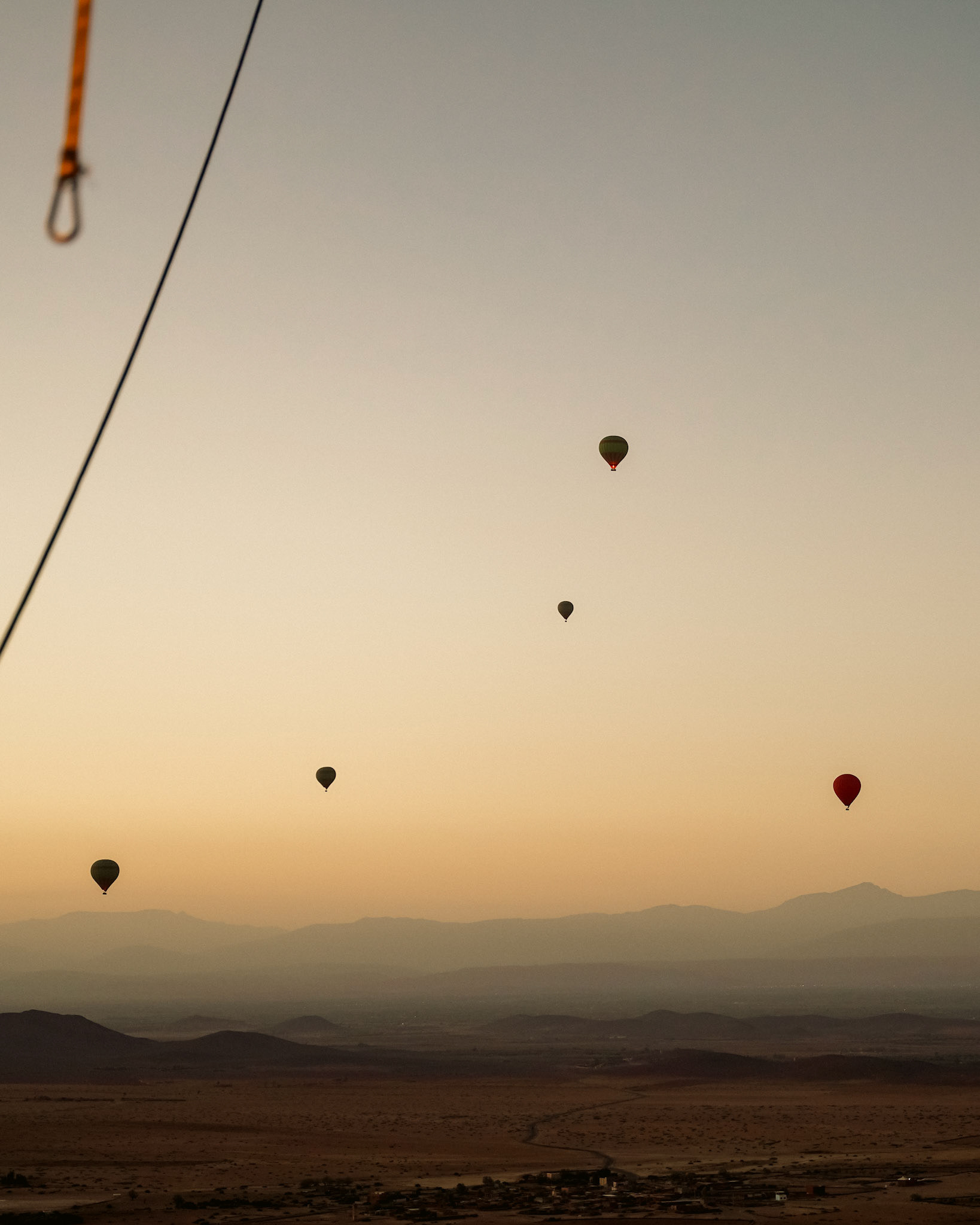 Hot air balloons over the vast desert landscape of Marrakech, Morocco