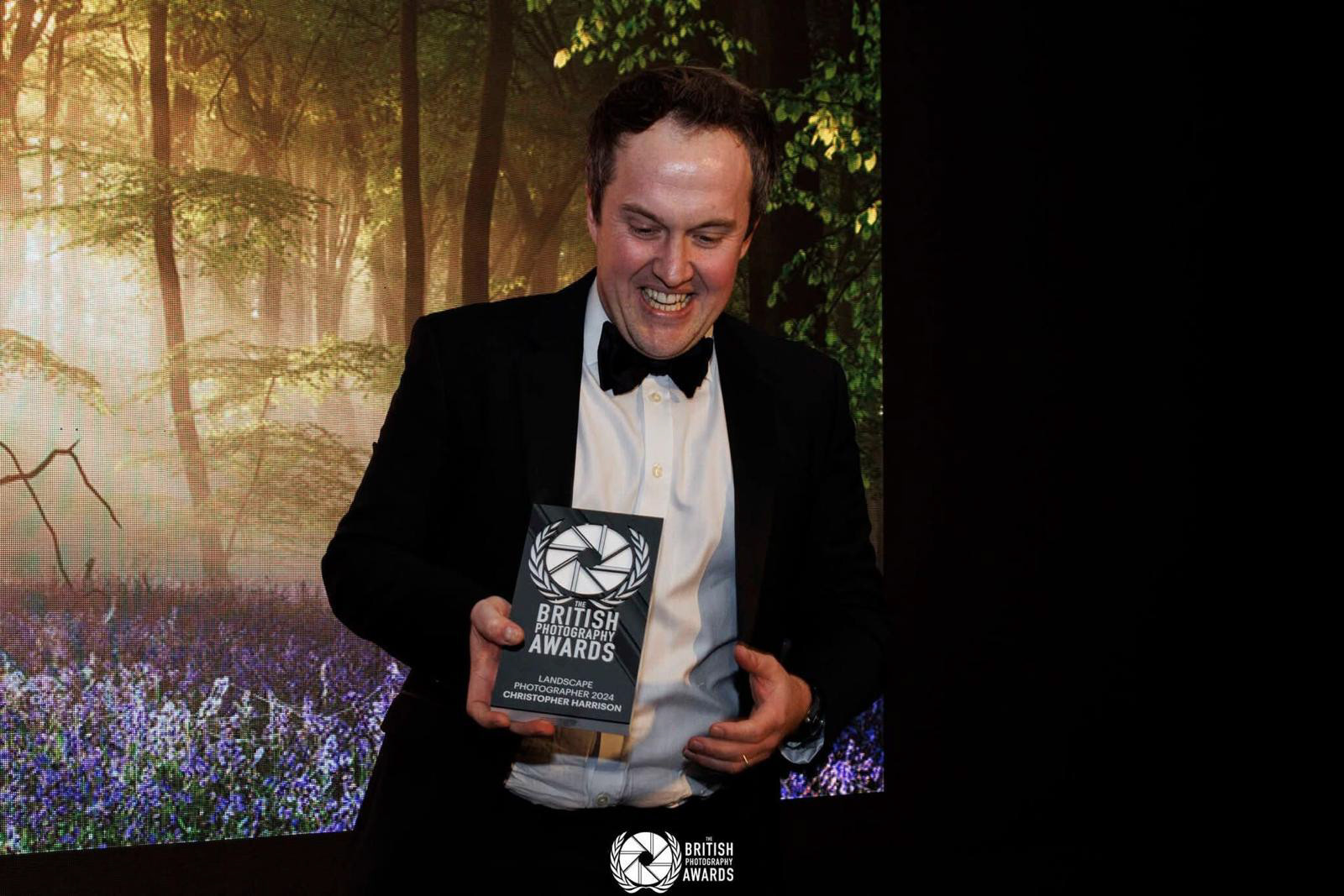 Christopher Harrison at the British Photography Awards in London, with his winning trophy from the Landscape Category where his image Bluebells at Sunrise won. 