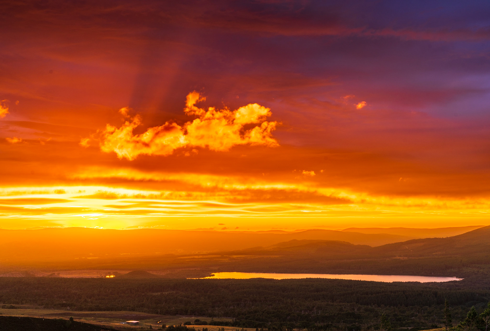 A warm summer sunset over the Cairngorms National Park, Loch Morlich, Scotland