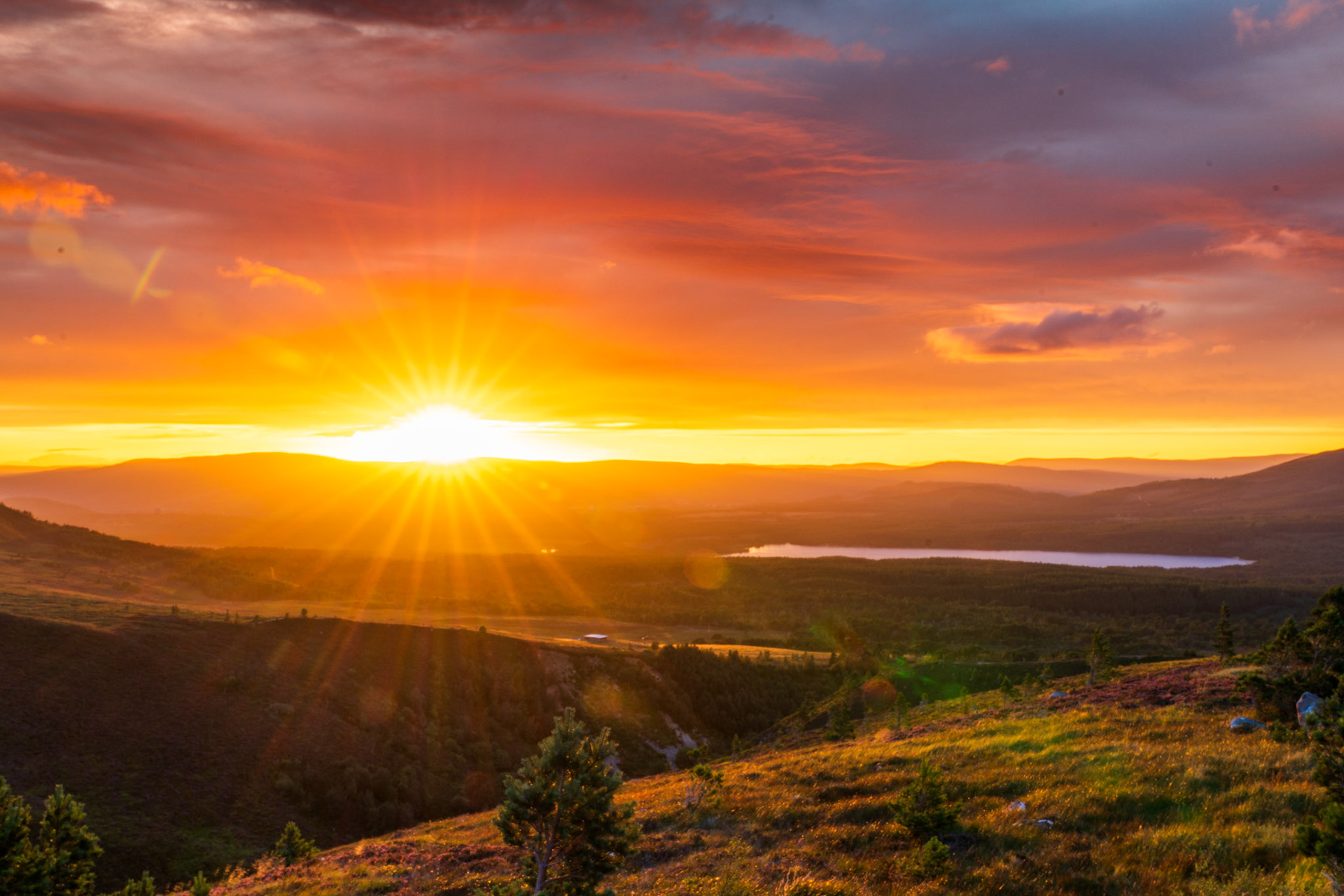 A warm summer sunset over the Cairngorms National Park, Loch Morlich, Scotland