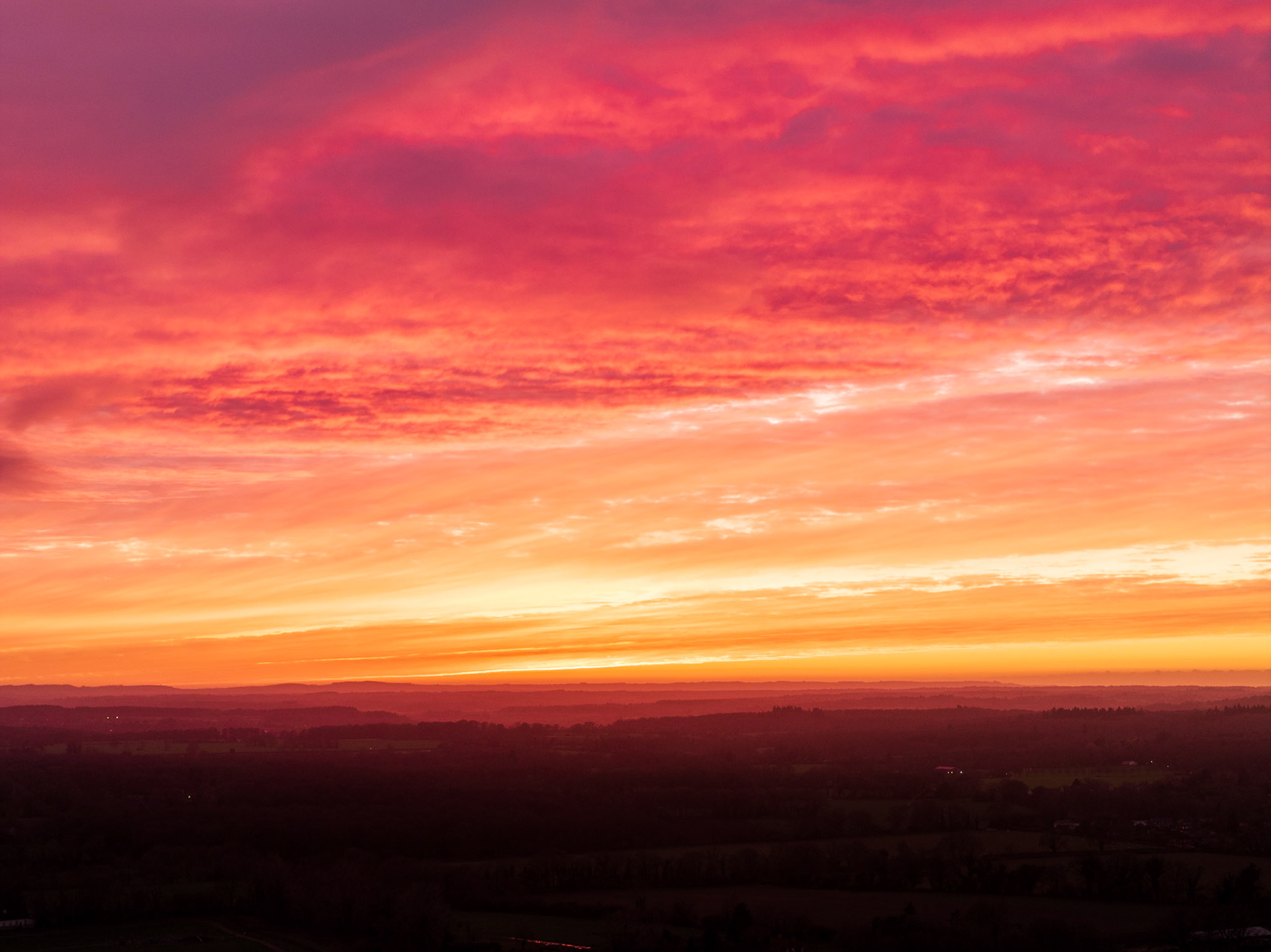 A wonderfully vivid red & orange sunset, looking over the rolling hills of Oxfordshire. Captured on the 70mm DJI Mavic 3 Pro camera.