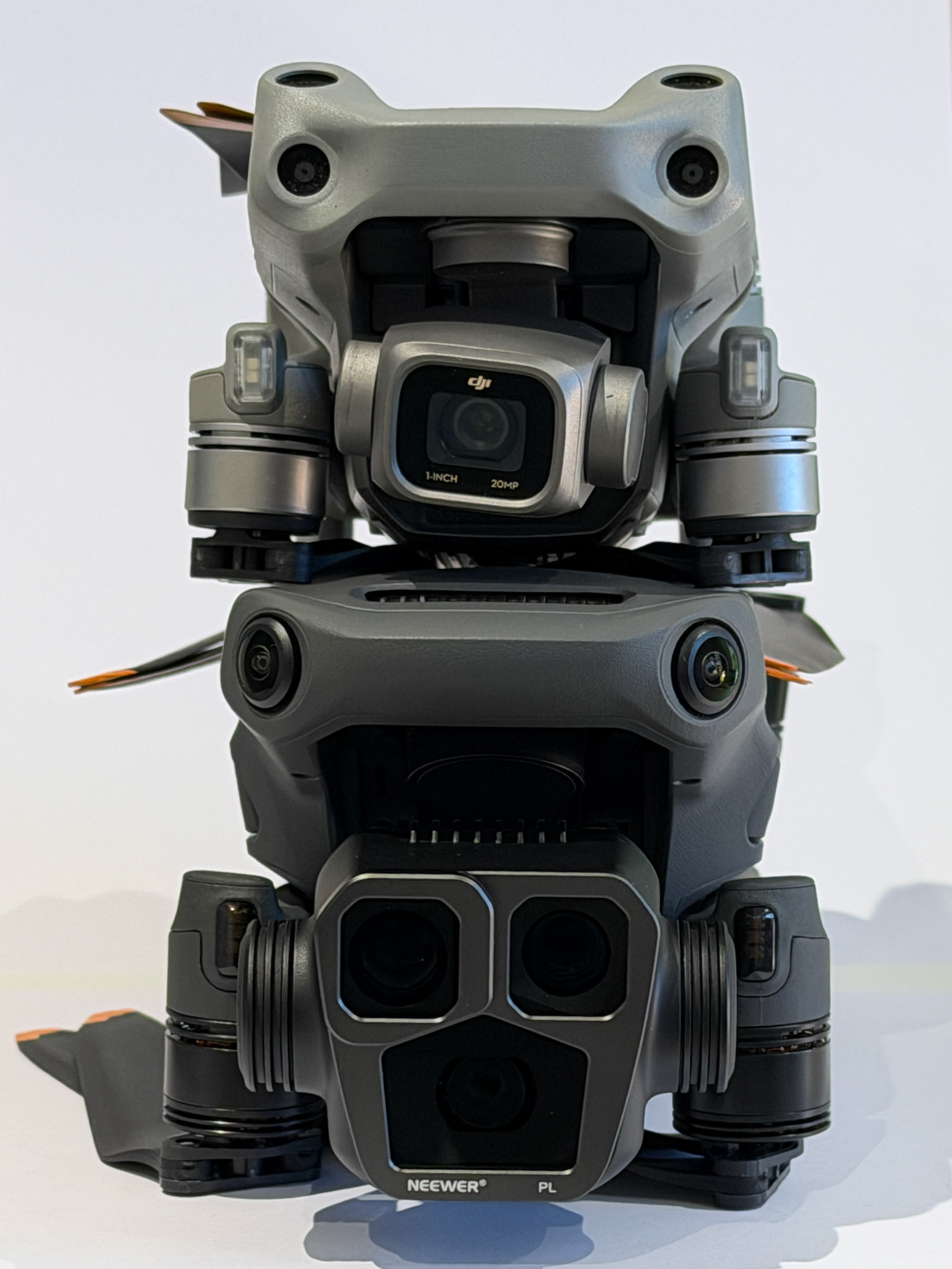 The DJI Air 2S on top of the Mavic 3 Pro drones, together. You can see the difference in size here, with the size of the camera units being a noticable improvement on the DJI Mavic 3 Pro.