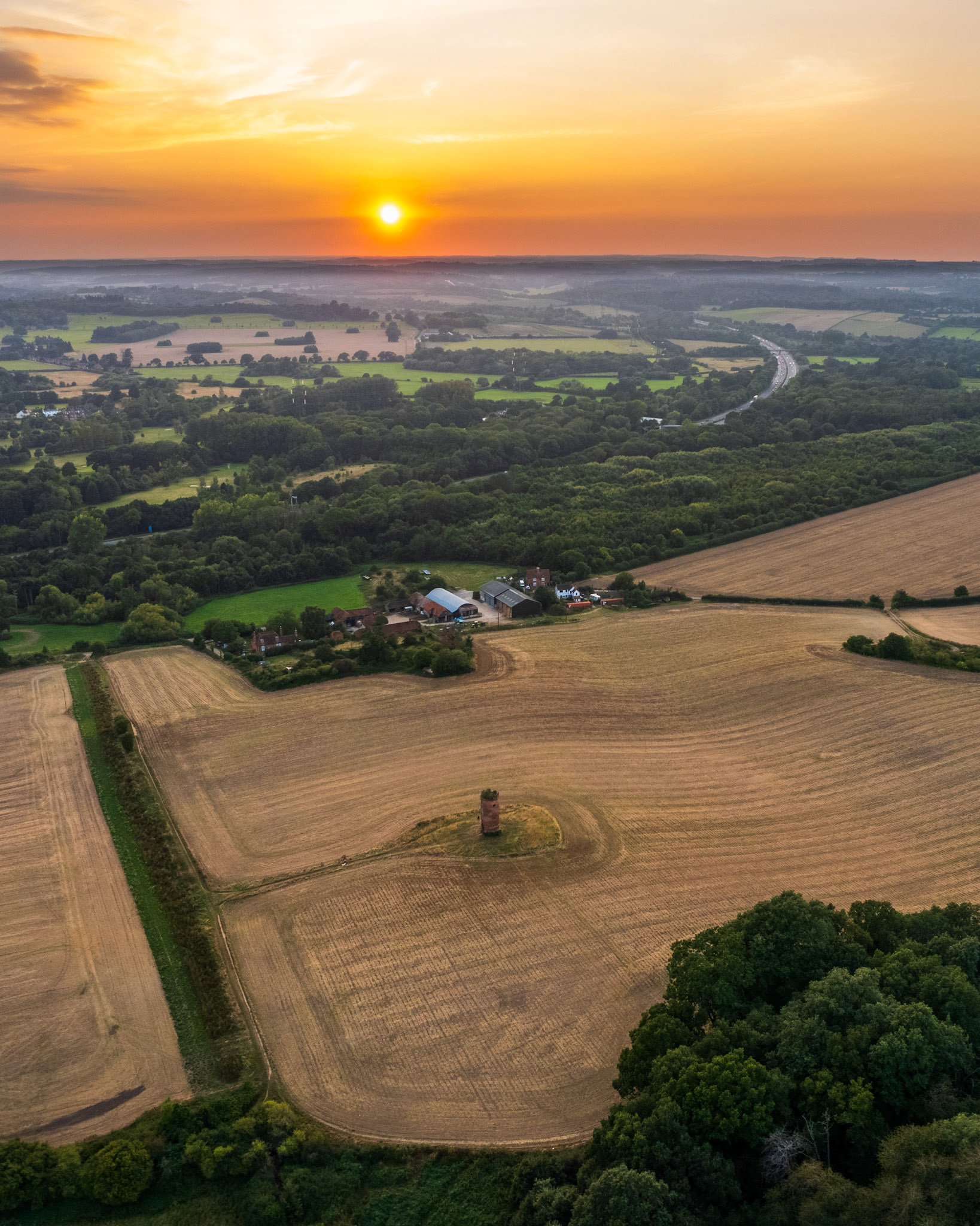 Wilders Folly in Berkshire, near Reading, UK. Taken from drone with a magical bright red sunset