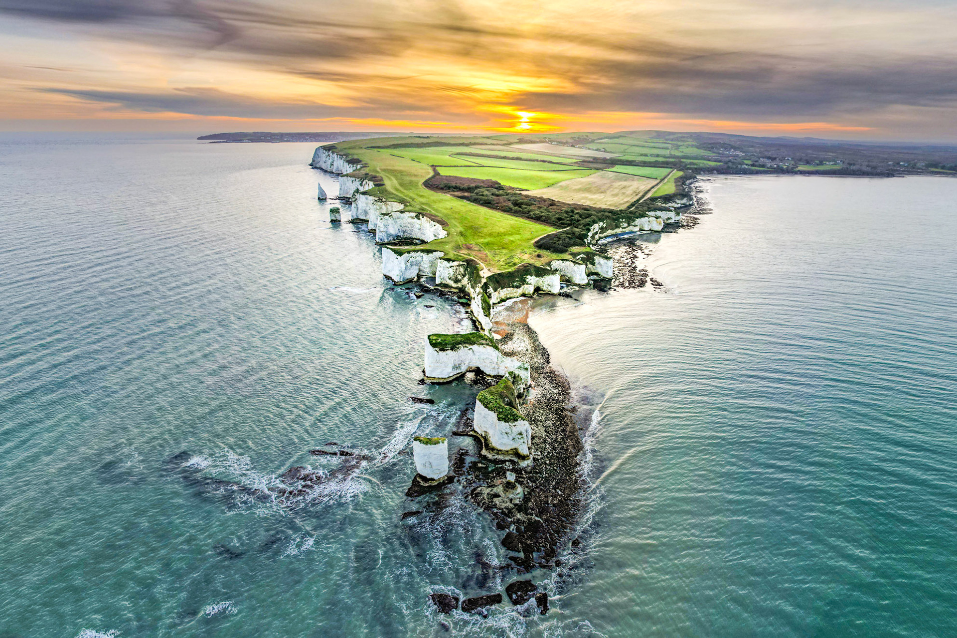 Old Harry's Rocks, Dorset, UK, from above. Sunset aligns with the rock formations.