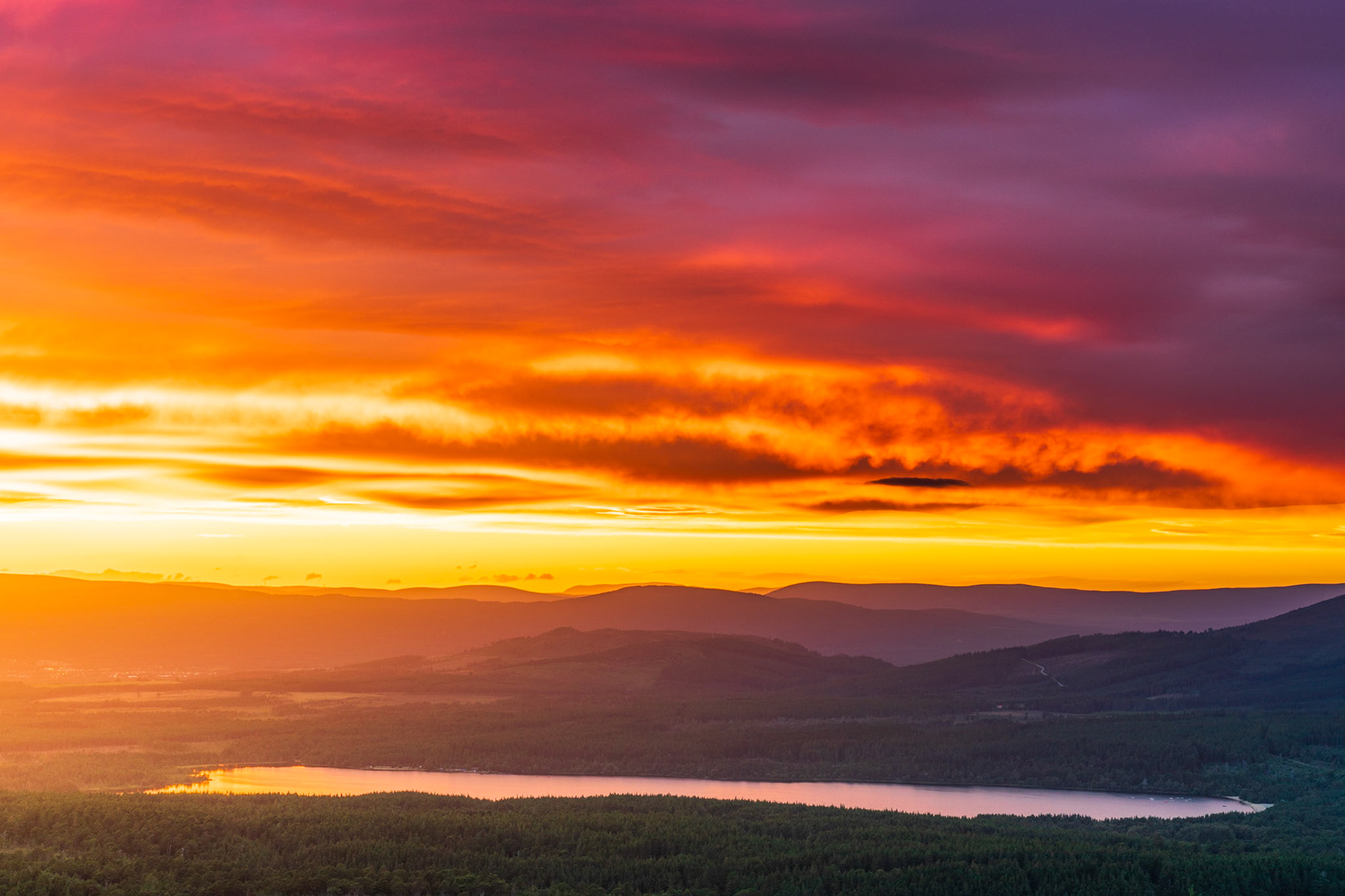 A warm summer sunset over the Cairngorms National Park, Loch Morlich, Scotland