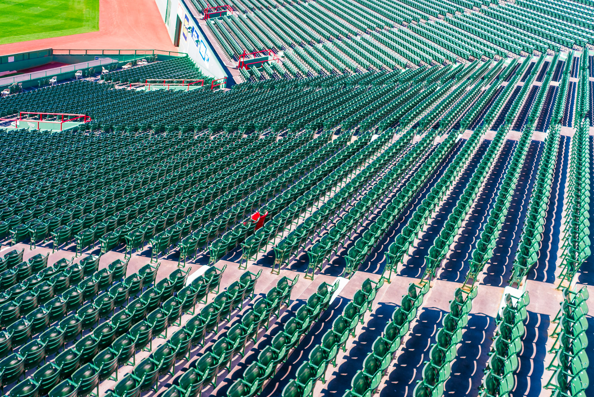 One red seat among a sea of green, marking where Ted Williams’ legendary 502-foot home run landed in 1946—the longest ever recorded at Fenway Park.