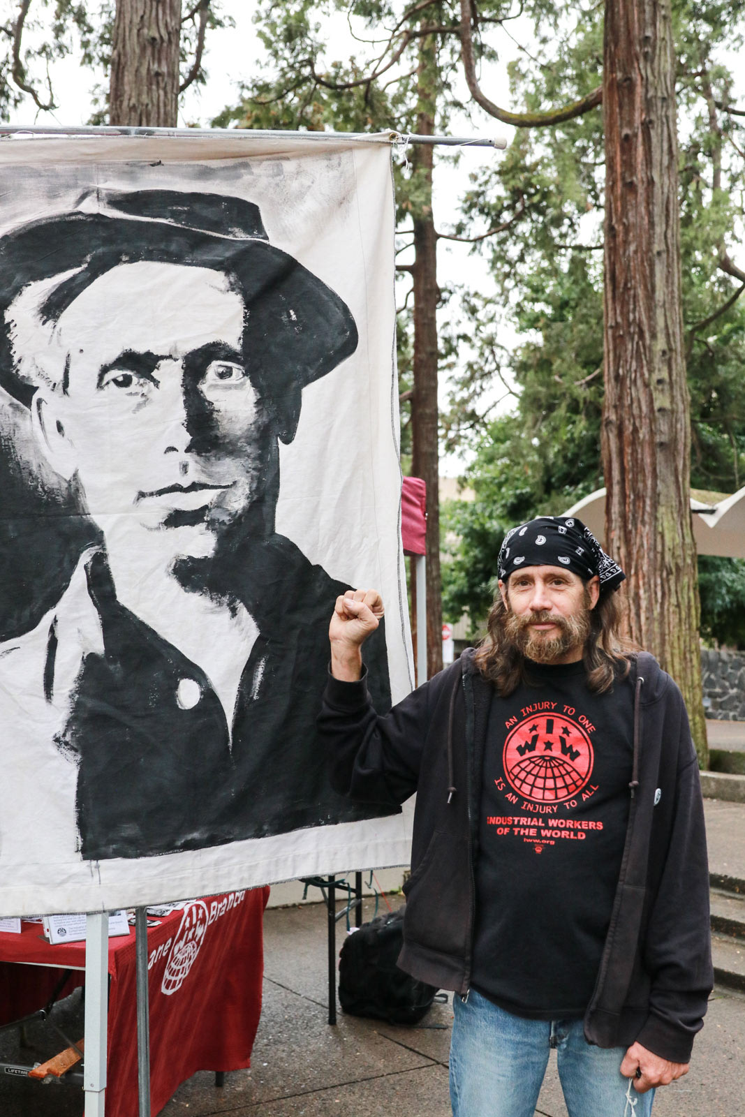 Man makes solidarity fist gesture in Eugene Park Blocks